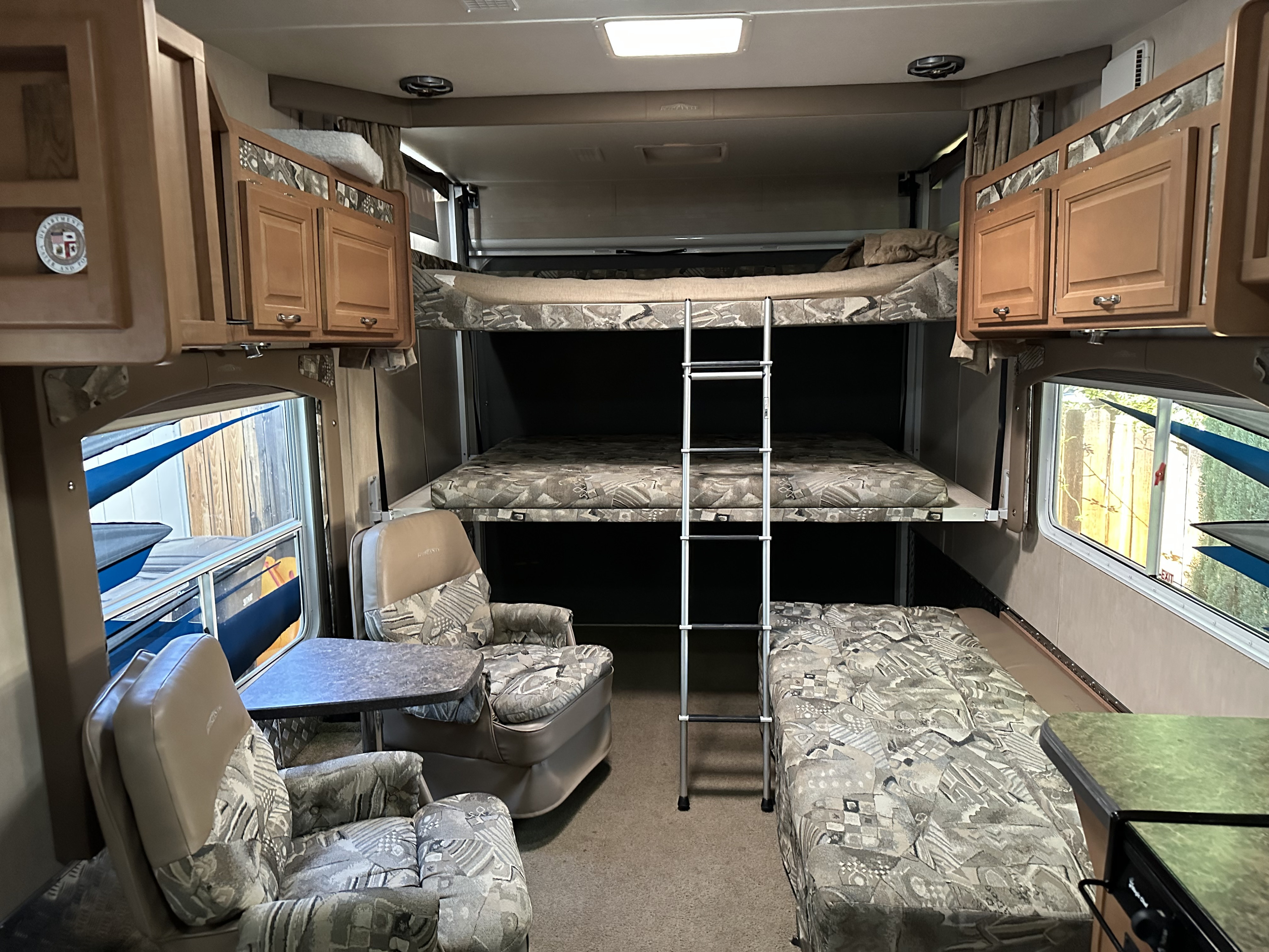 Inside this RV rental, find versatile bunk beds with a ladder, comfortable recliners, and storage cabinets.. Weekend Warrior Widelite Wlfs 2600 2008