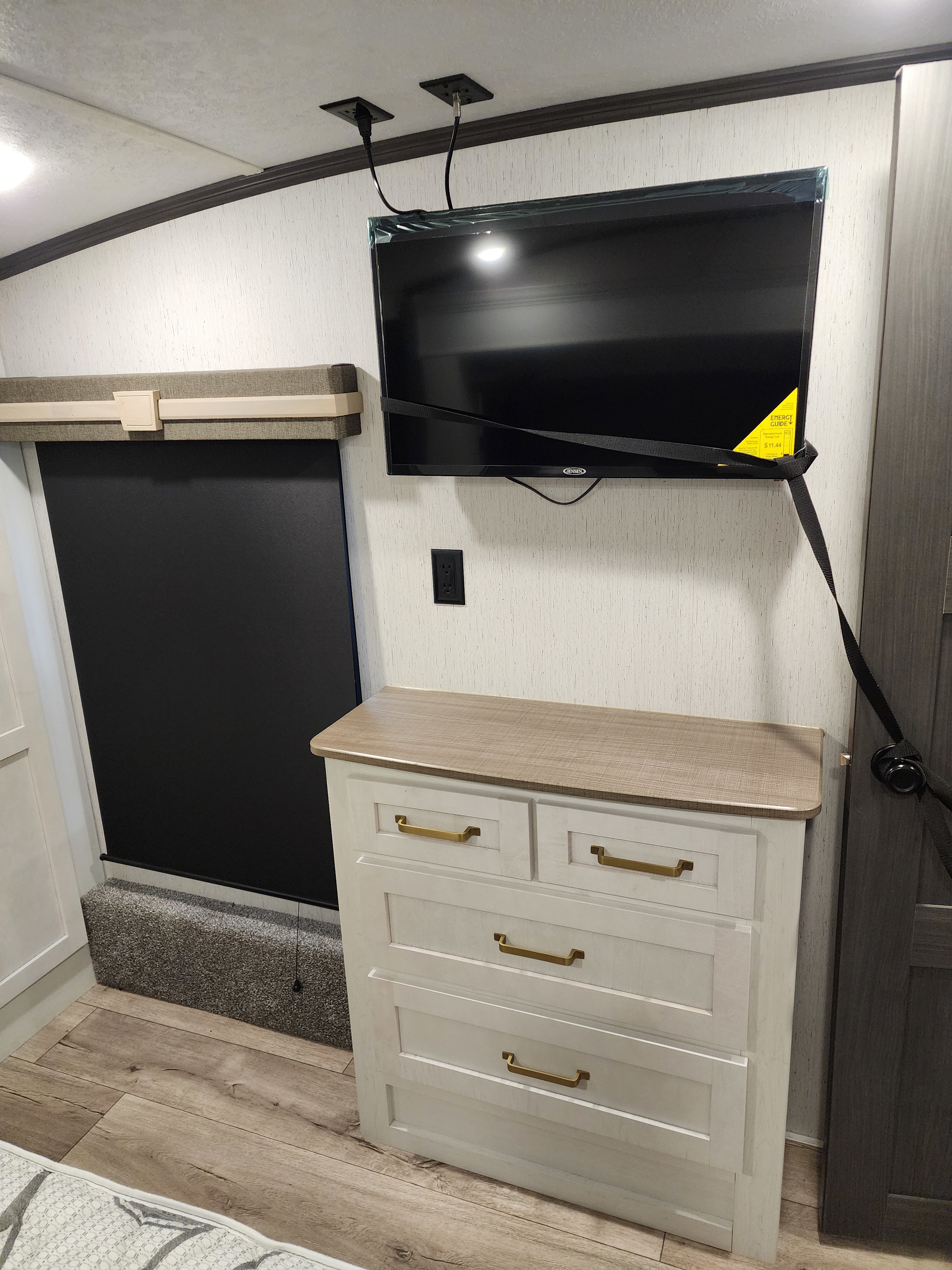 RV rental bedroom: Wall-mounted TV, dresser & window shade enhance this cozy RV interior.. Keystone RV AA3603LFP22 2022