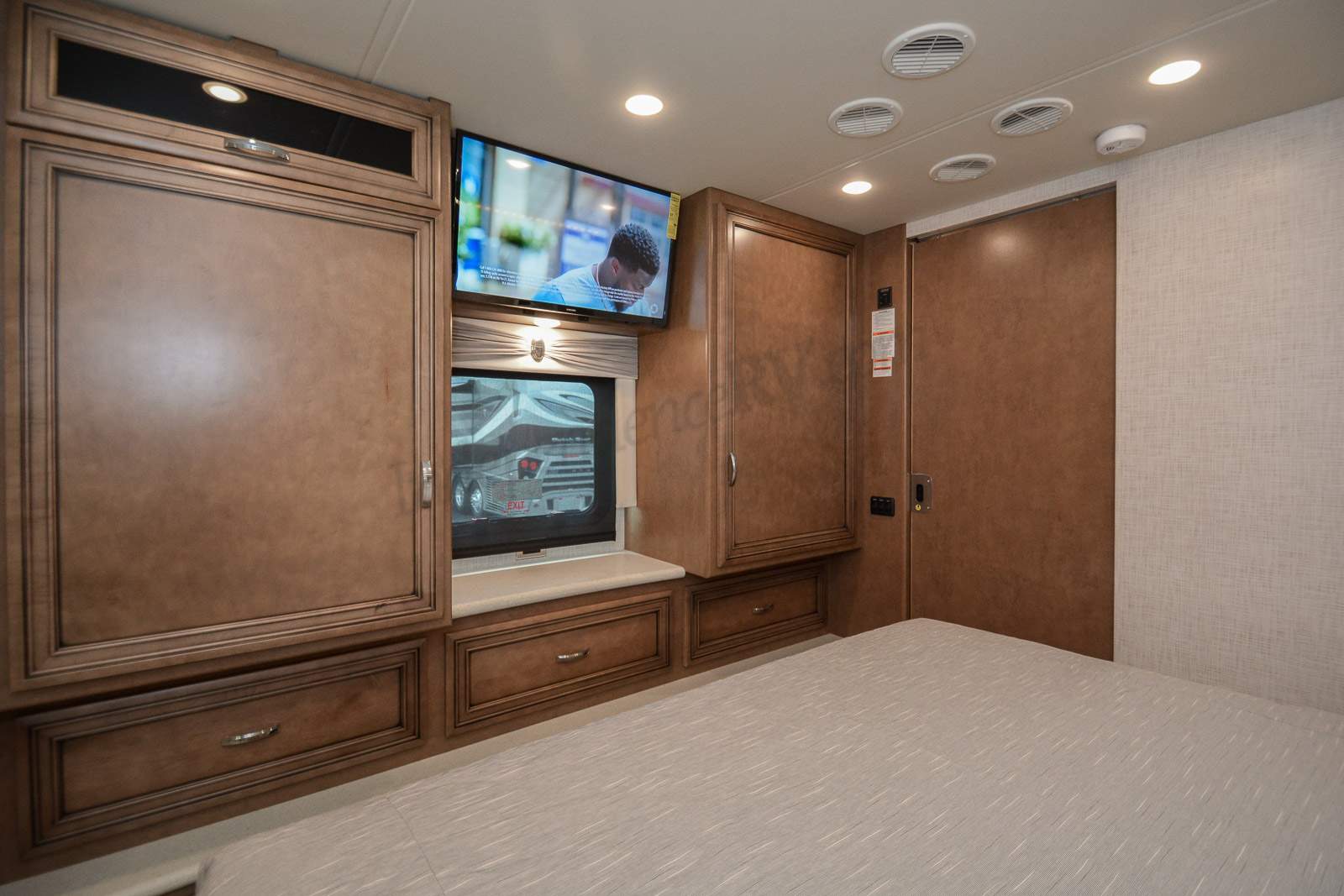 Cozy RV rental bedroom with TV, window, and built-in storage.. Bay Star Bay Star Motorhome 2022
