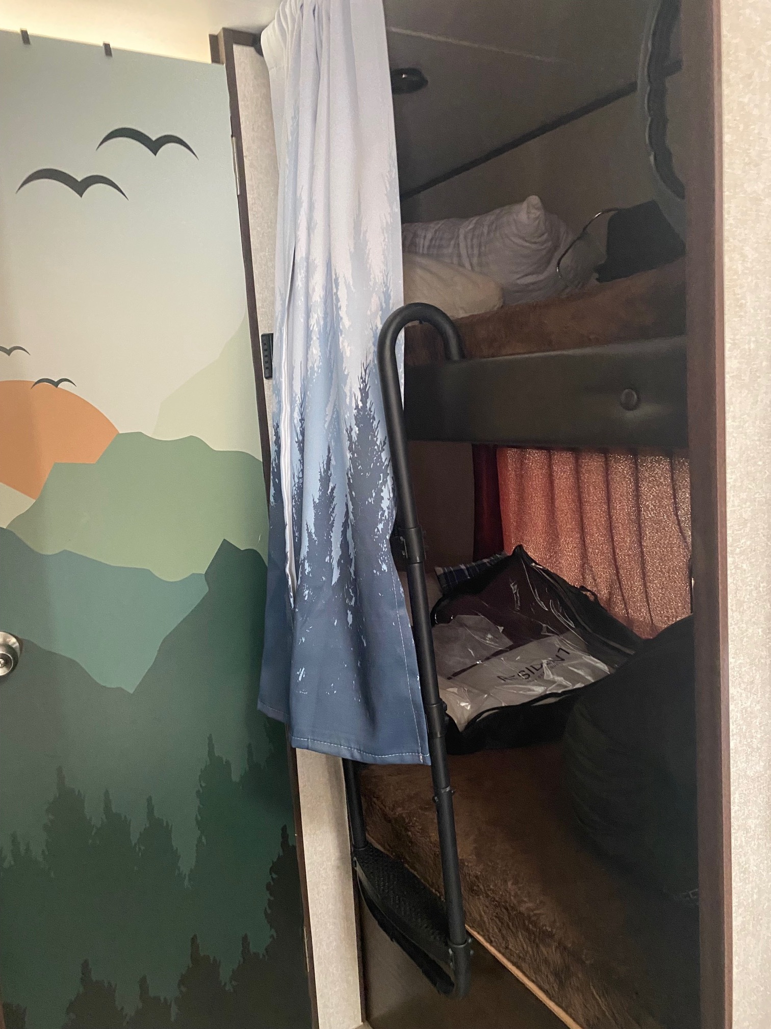 An RV rental features bunk beds with a ladder & a custom door mural depicting mountains, trees, and flying birds.. Jayco Jay Flight SLX 2019
