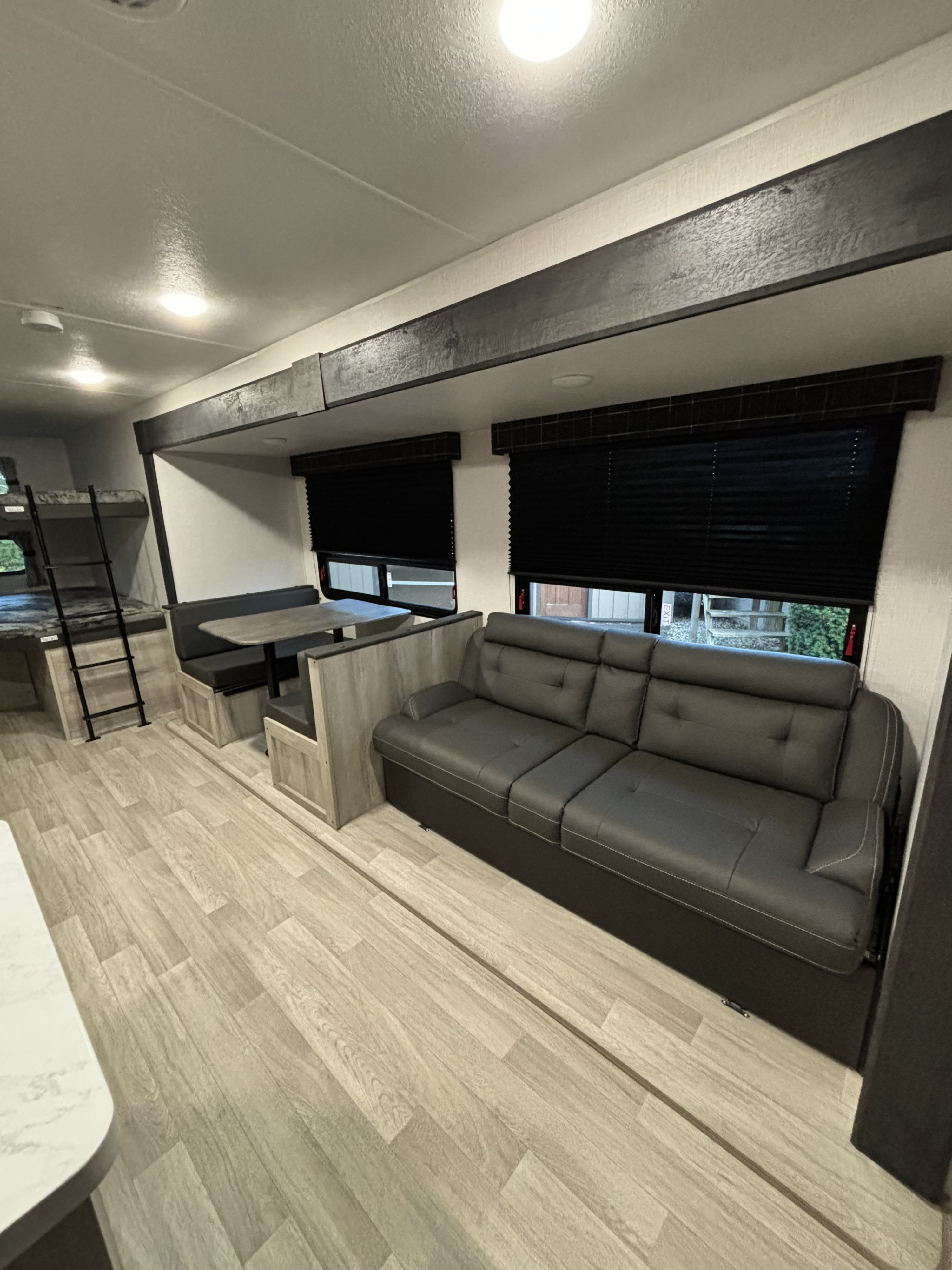 Experience comfort in this modern rv rental: spacious interior with bunk beds, dinette, and a large sofa.. Sportsmen 261BHKSE 2024