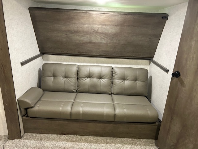 RV rental: Compact interior with a multi-person sofa and a convertible bunk bed folded up overhead.. Forest River Salem 2020