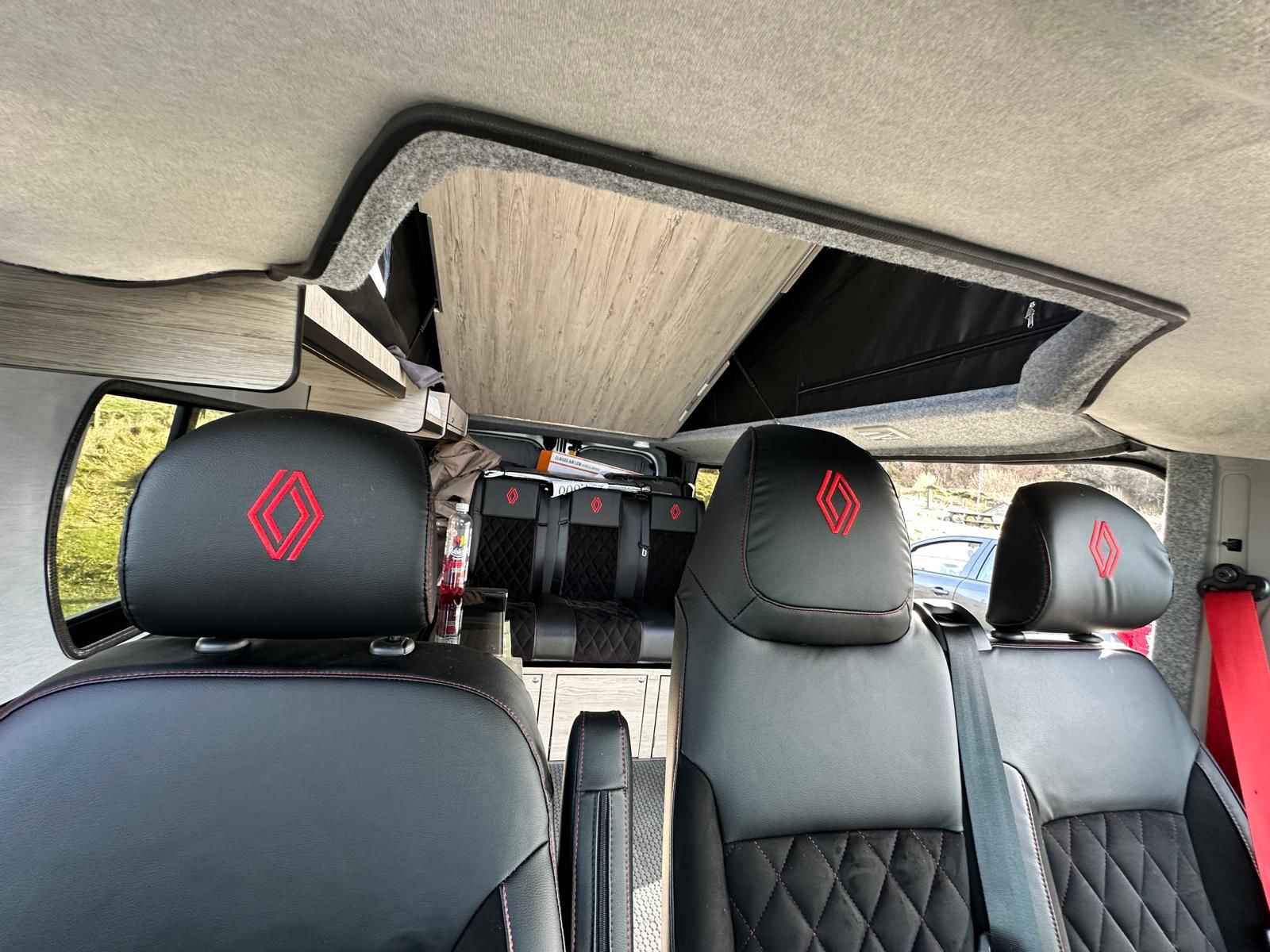 Spacious RV rental with custom Renault interior. Pop-top roof, black leather seats with red stitching.. Renault Other 2023