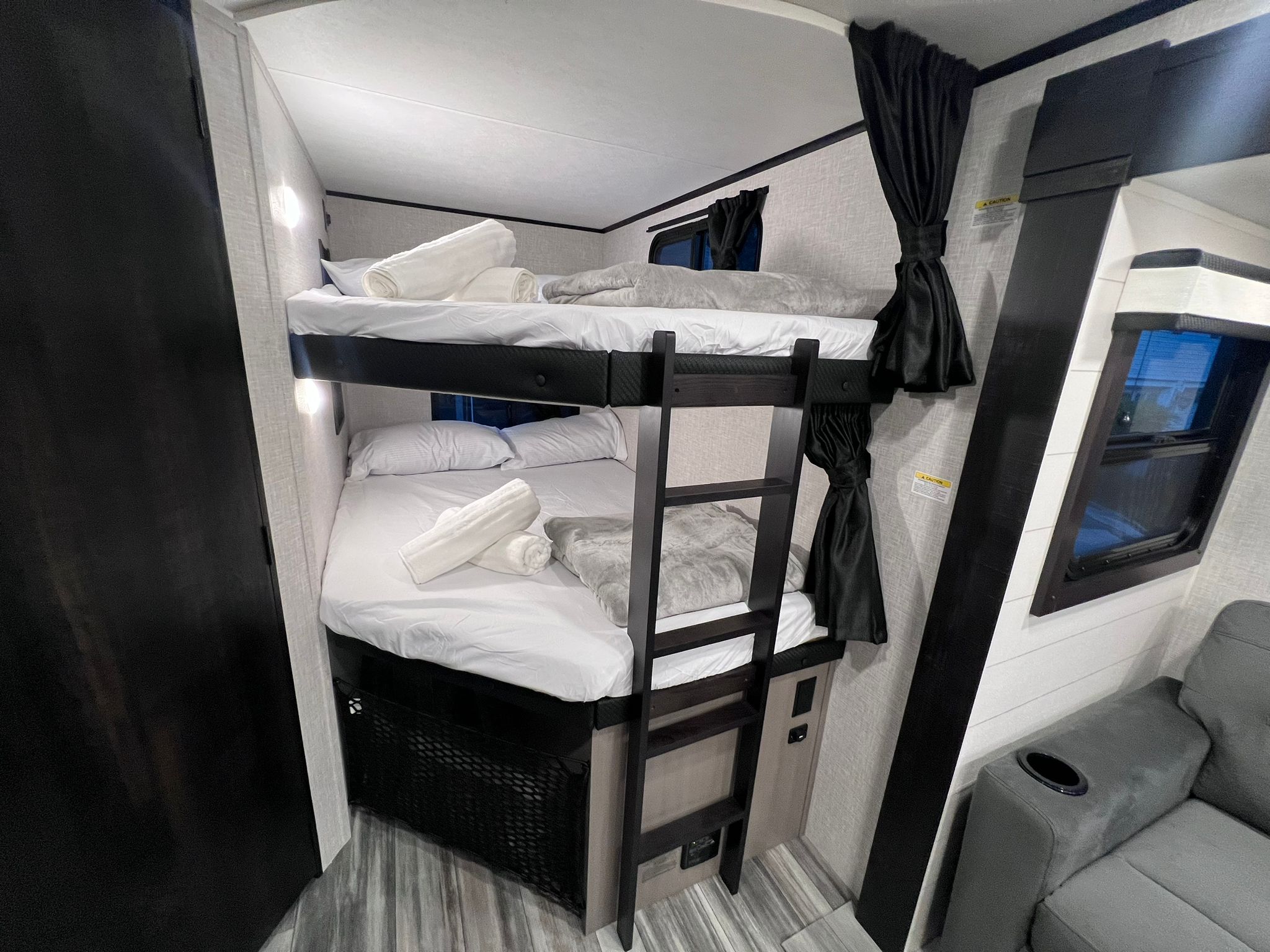 This RV rental offers comfortable bunk beds, complete with fresh linens and individual lighting, plus a cozy seating area.. Jayco Jay Feather 2024