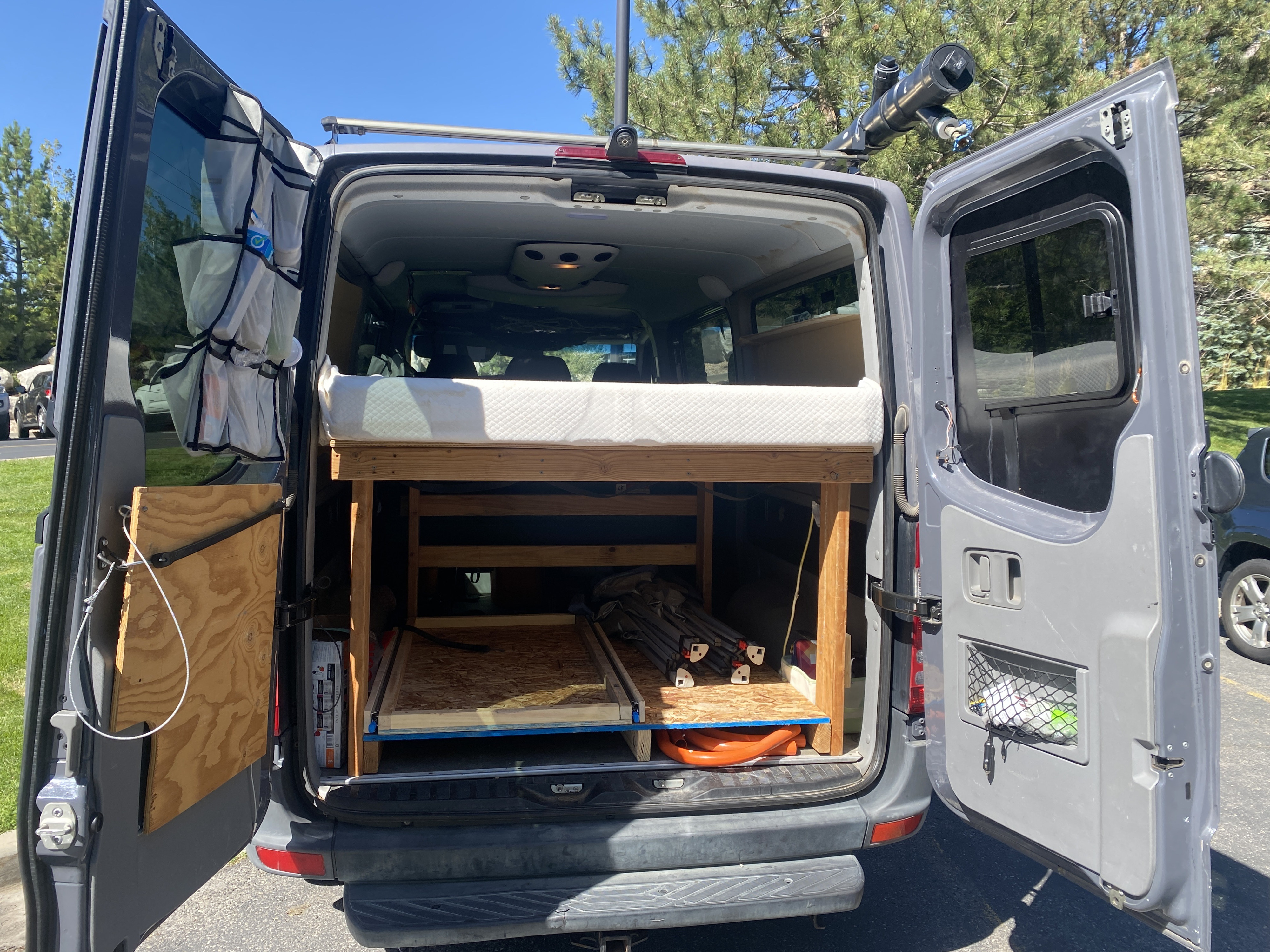 This RV rental camper van features a clever custom interior with a high bed, pull-out storage, & roof rack gear.. Mercedes Sprinter 2011