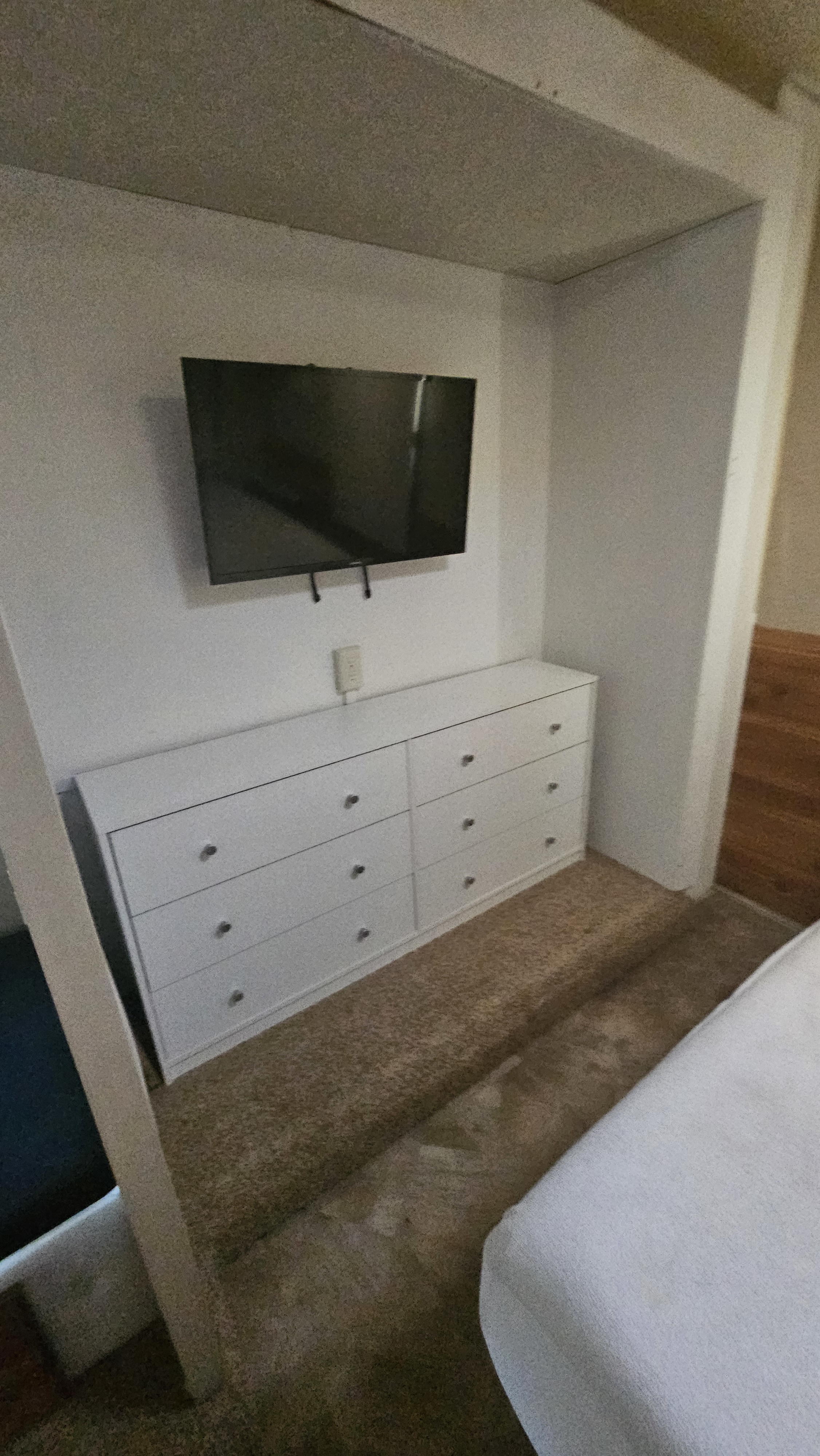 RV rental: Compact interior showing a mounted TV above a white dresser, offering space-saving storage.. Jayco Redhawk 2016