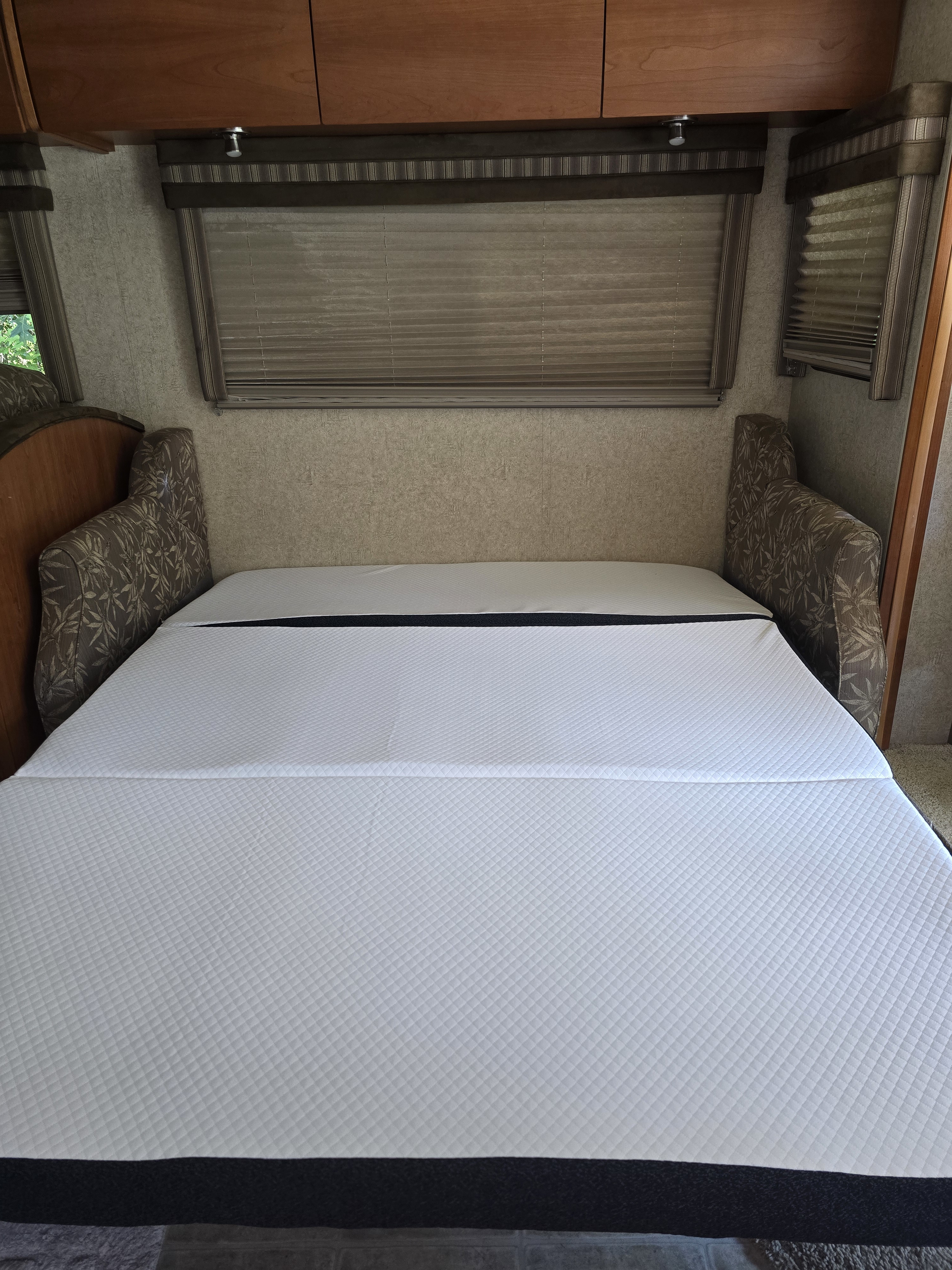Spacious RV interior featuring a comfy, foldable white quilted mattress – ideal for your next rv rental adventure.. Winnebago Sightseer 2008