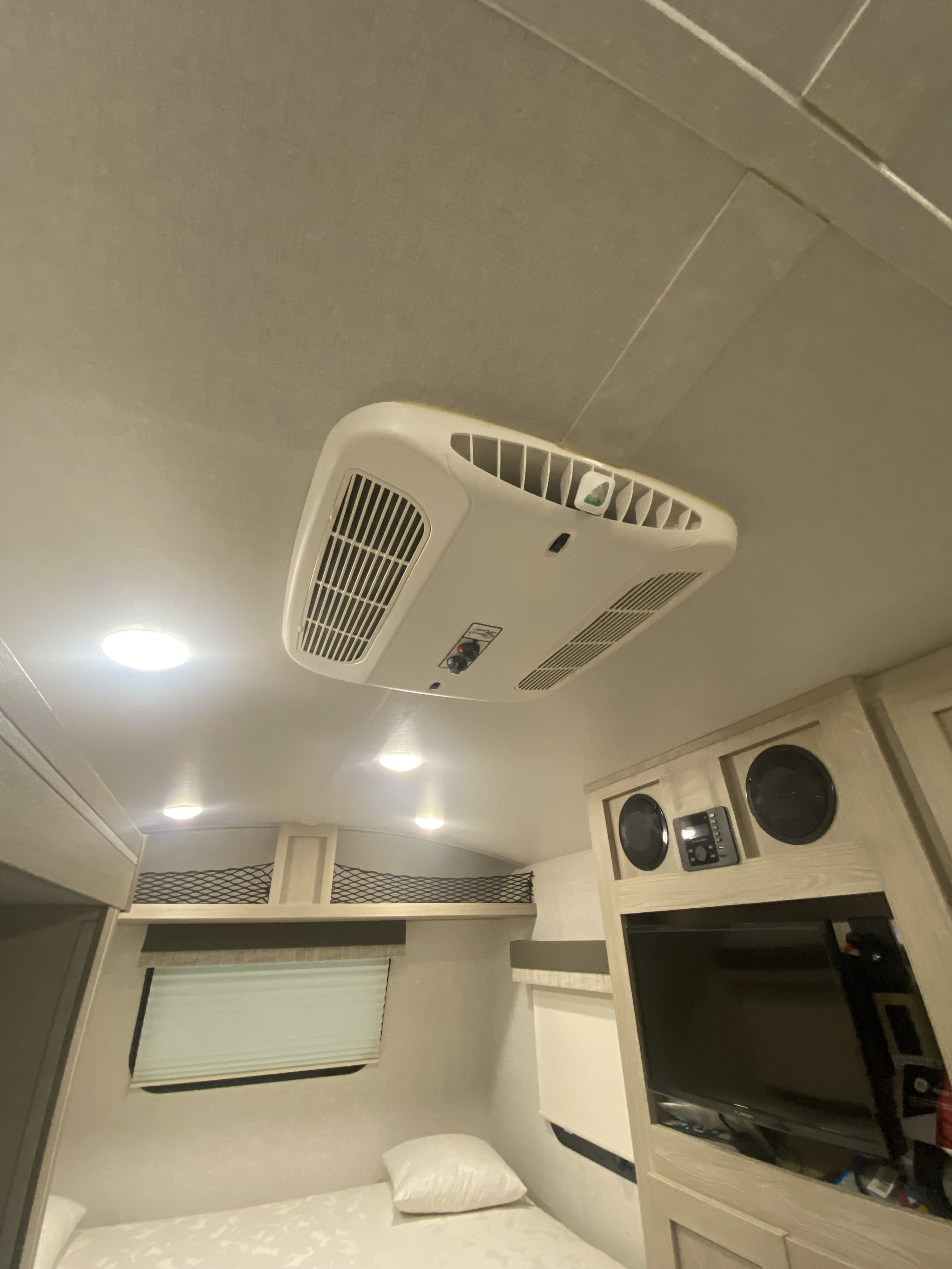 RV rental interior: a comfy bedroom with ceiling AC, window, bed, and entertainment system, ready for your trip.. Forest River Flagstaff E-Pro 2022