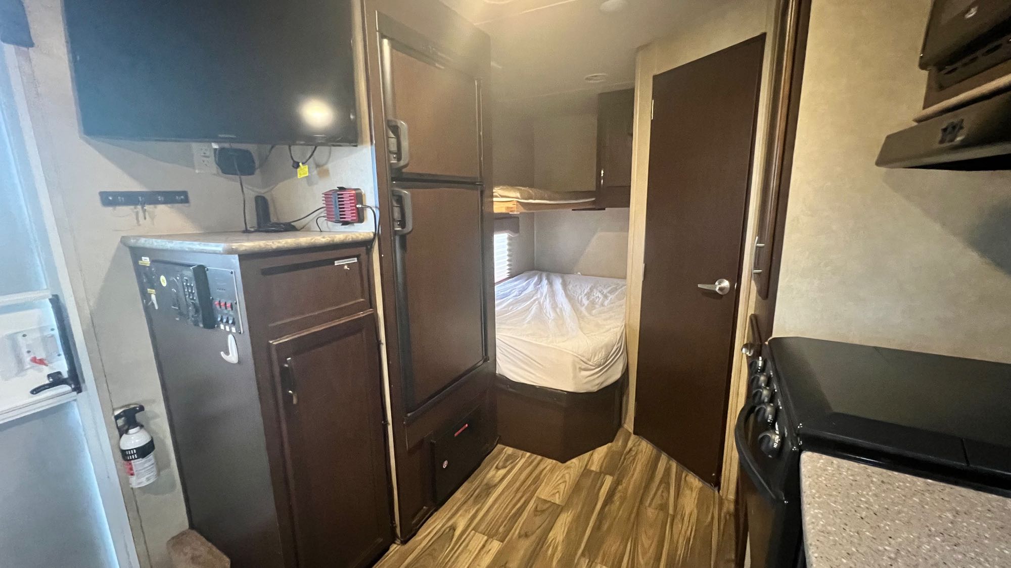 Inside an RV rental: features include a living area with TV, kitchen, and cozy bunk beds. Ideal for your next adventure.. Forest River T1860 2016