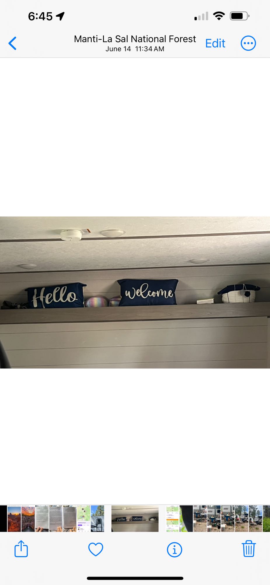 Cozy interior of an RV rental featuring 'Hello' and 'Welcome' pillows on a shelf, perfect for a comfortable mobile stay.. Dutchmen Coleman Lantern LT 2024