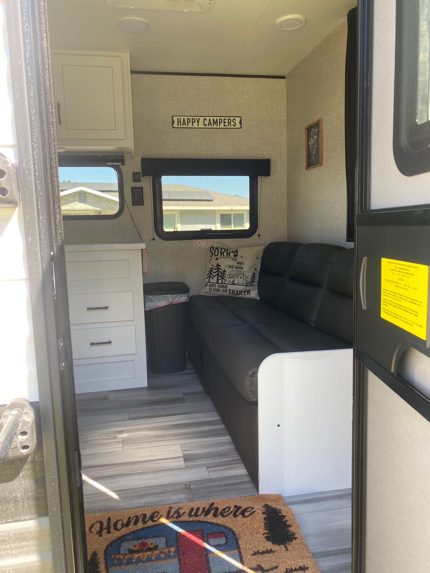 Cozy RV rental interior with compact kitchen, comfy couch, and fun camping decor. Ready for adventure!. Jayco Jay Flight SLX 2024