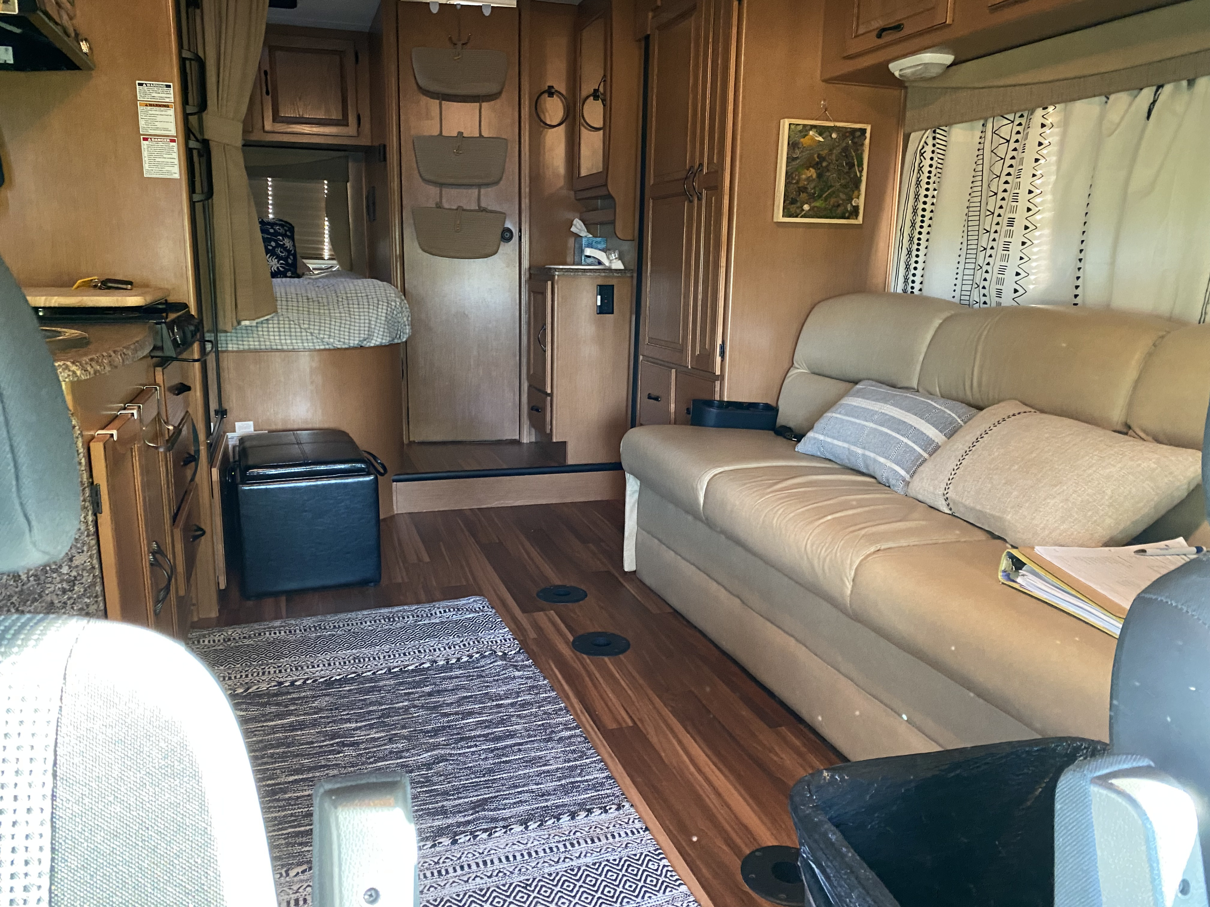 Inviting RV rental interior featuring a cozy bed, plush sofa, and functional living space.. Forest River Coachmen Prism 2014