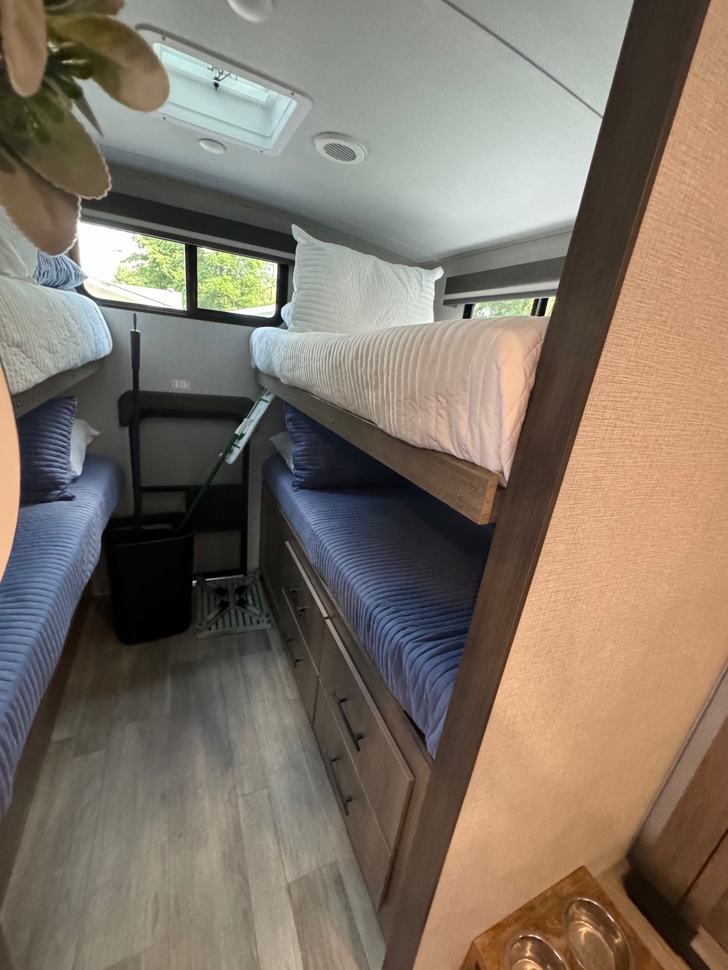 This RV rental provides two sets of bunk beds with blue & white bedding, windows, and drawers for storage.. Grand Design Imagine 3210BH 2023