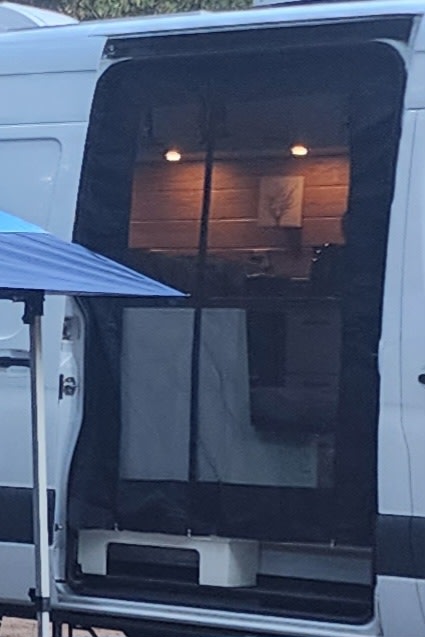 Step inside this custom RV rental. See the cozy wood-paneled interior, warm lighting, and unique decor of a camper van.. Mercedes Sprinter 1500 2020