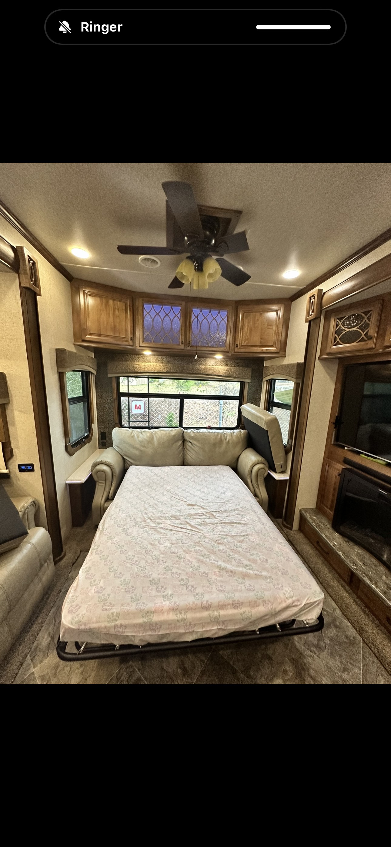 RV rental living area with pull-out bed, cozy sofa, and ceiling fan for a comfortable stay.. Heartland RVs Landmark 365 2018