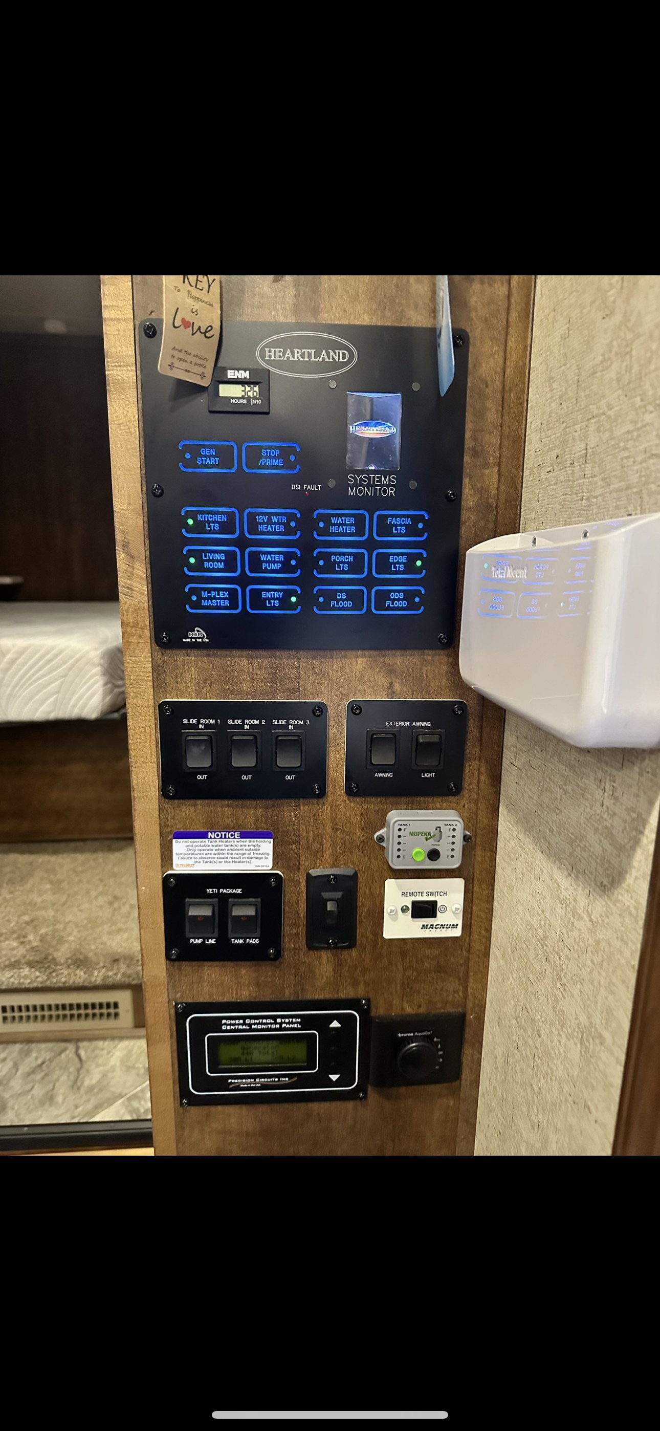 Heartland RV rental control panel: generator, lights, water, slide-outs, and tank monitors. Ideal for a safe trip.. Heartland RVs Landmark 365 2018