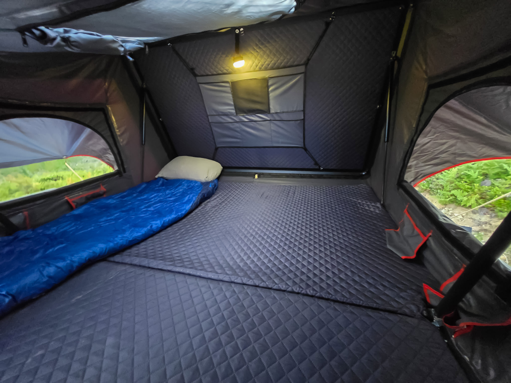 Explore comfortable camping with this RV rental rooftop tent interior. Features sleeping area, quilted walls, light & windows.. Toyota Tacoma TRD Offroad Premium 2021