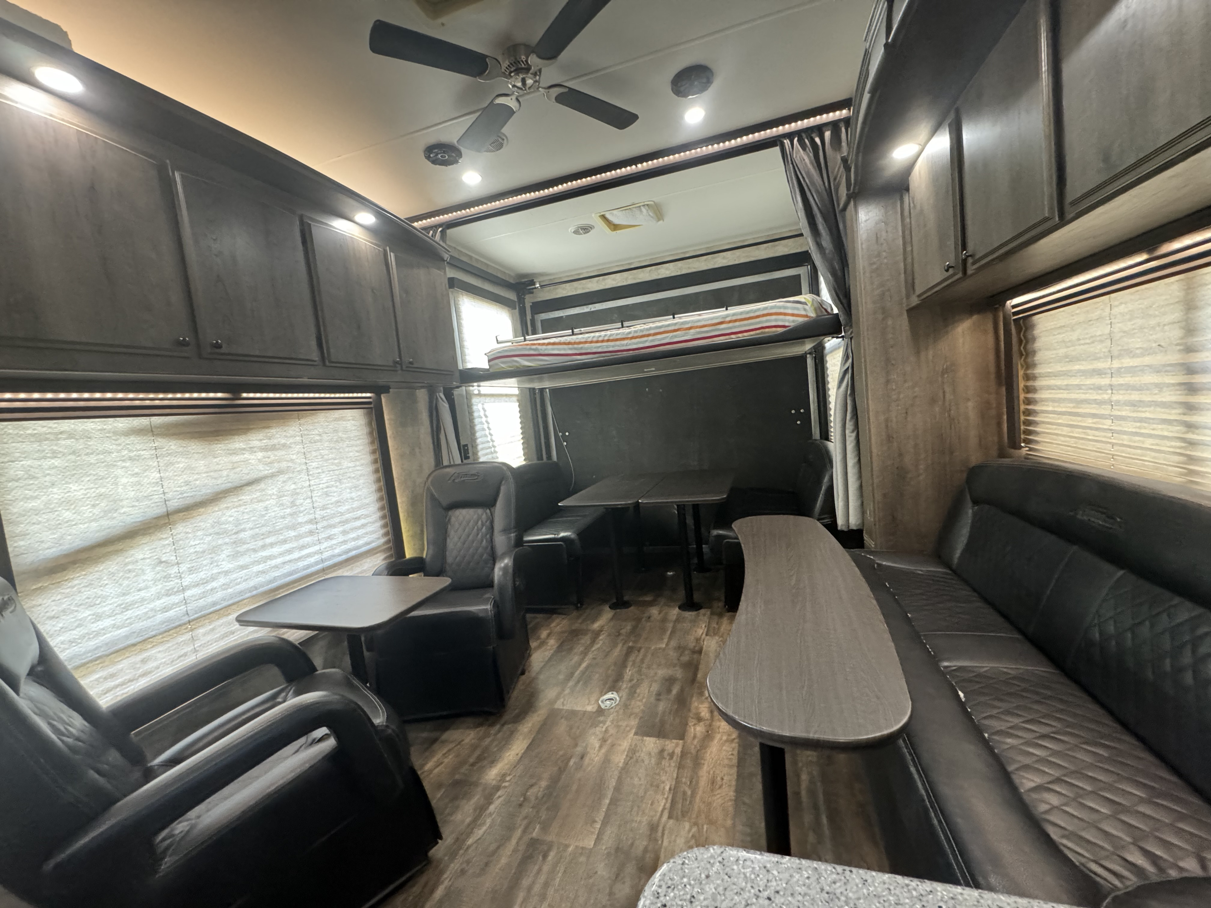RV rental's spacious interior: bunk bed, comfy seating, tables, overhead cabinets, and ceiling fan.. Eclipse Recreational Vehicles Attitude 2018
