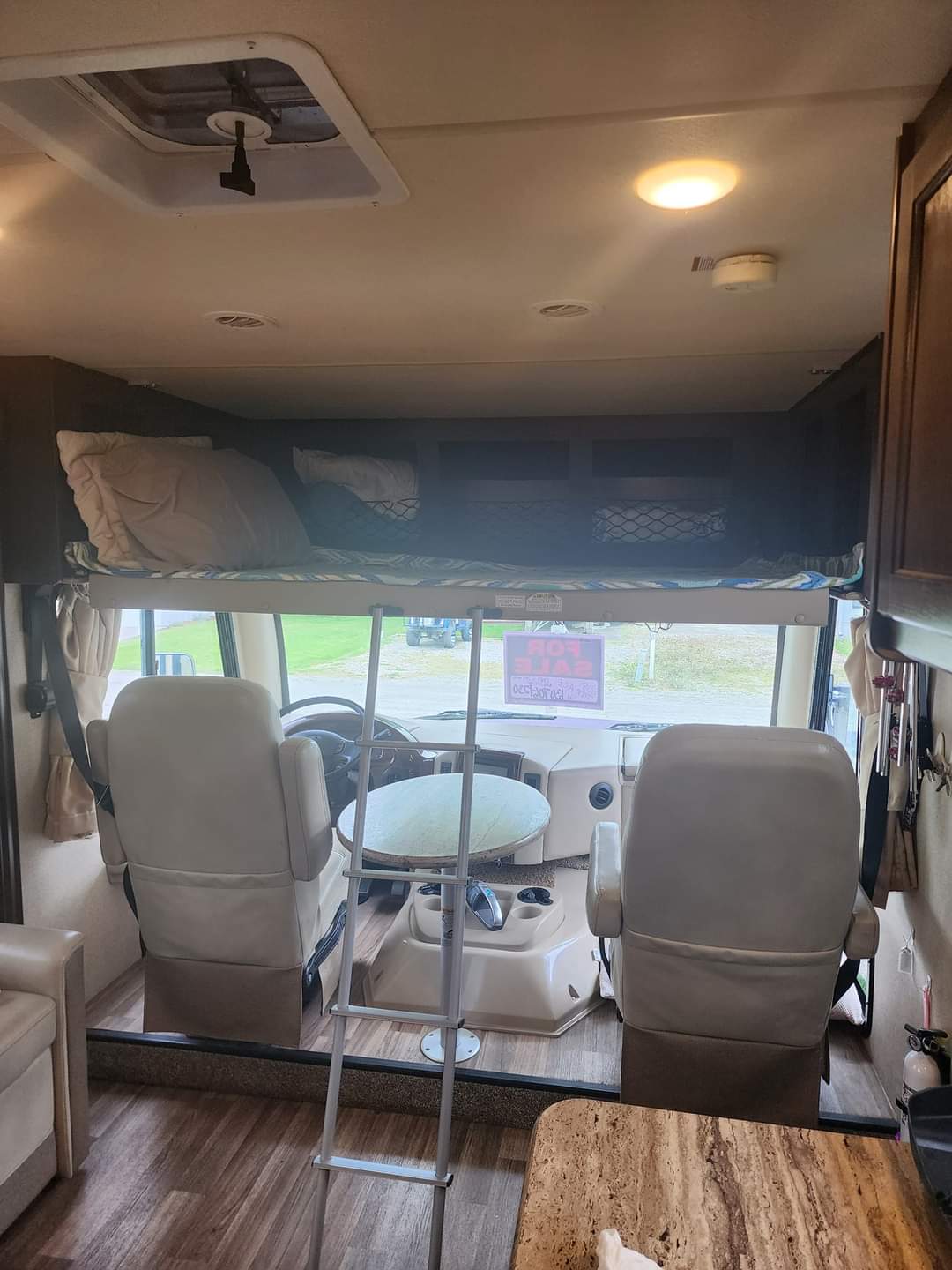RV rental: Bright, open interior features an overhead bunk with ladder, leading to spacious front cockpit seating.. Thor A.C.E. 2018