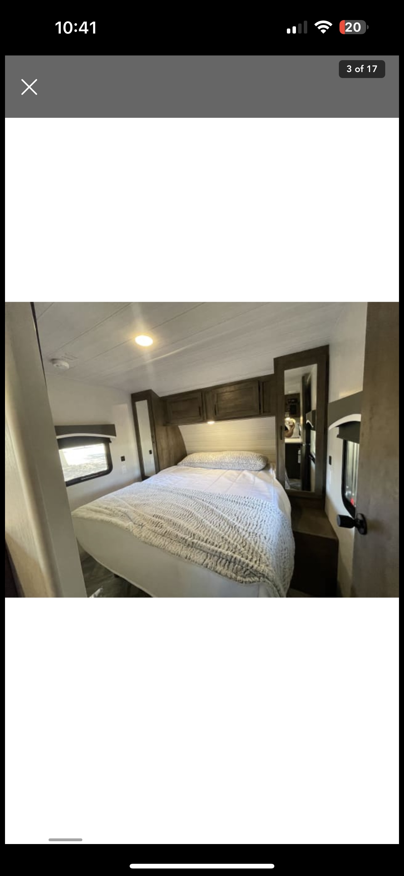 Comfortable RV rental bedroom with a large bed, overhead storage, and a mirrored wardrobe, providing cozy sleeping space.. Forest River Evo T2490 2022