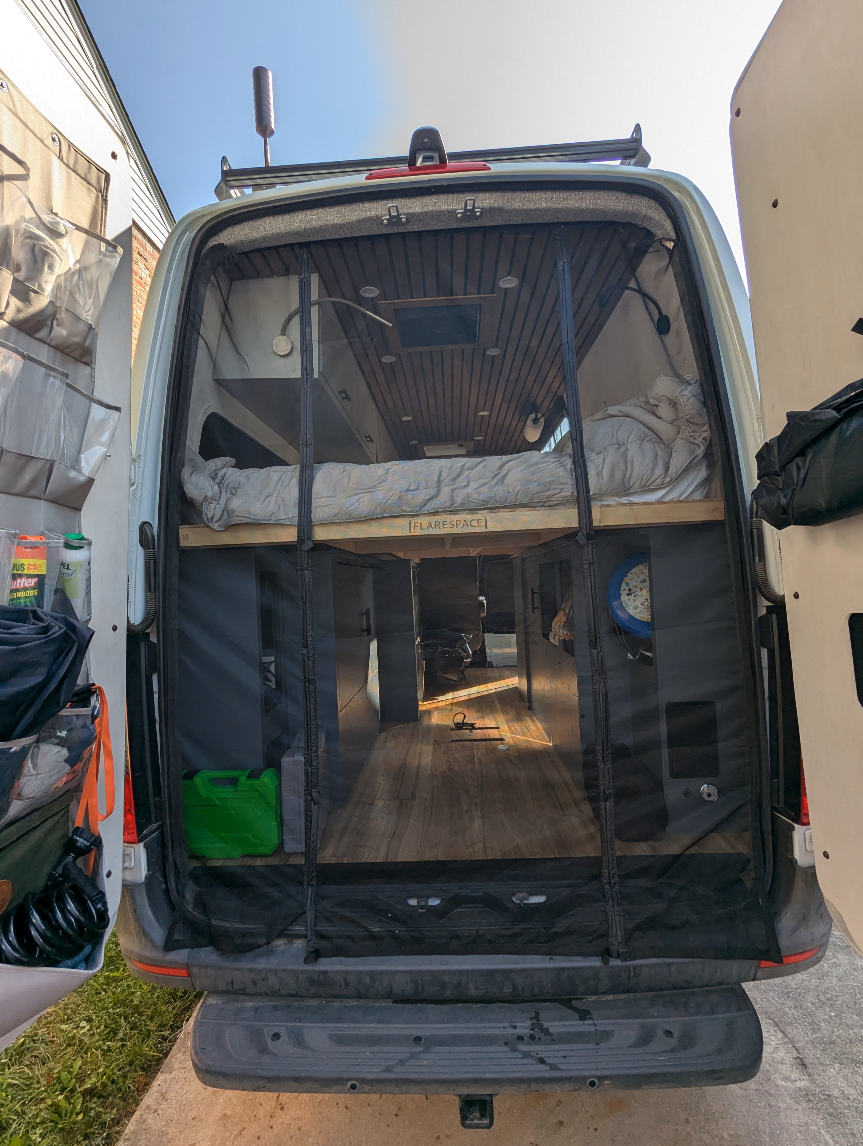 View into a converted camper van, featuring a raised bed & spacious interior, ideal for your next RV rental.. Mercedes-Benz sprinter 2020