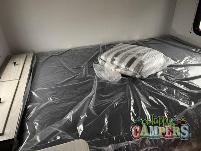 RV rental ready: A new, plastic-covered bed and pillow inside, awaiting happy campers.. Riverside Rv Intrepid 2023