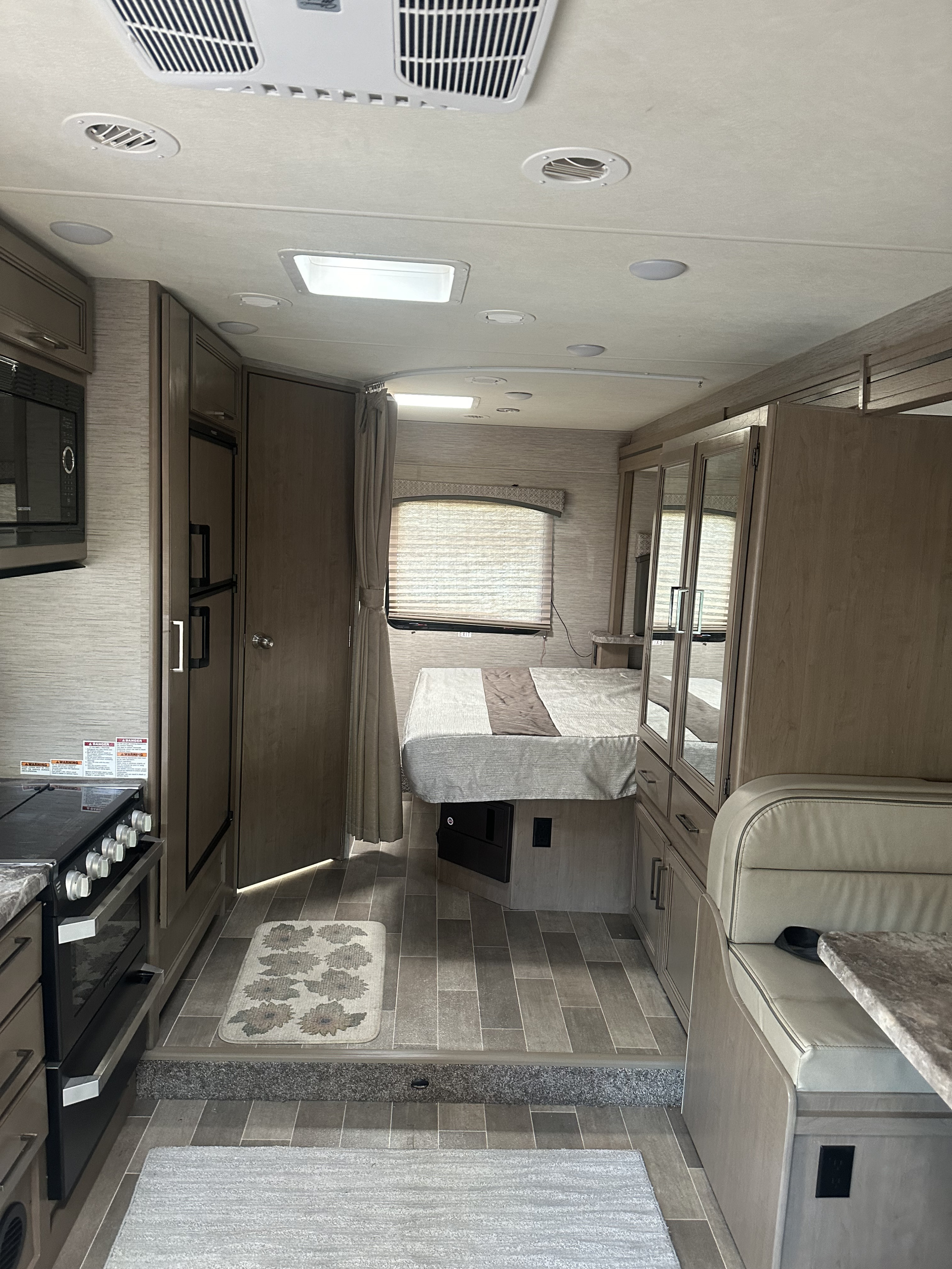 RV rental: full interior view showing kitchen appliances, a cozy bedroom, and dinette seating.. Thor Chateau 2021