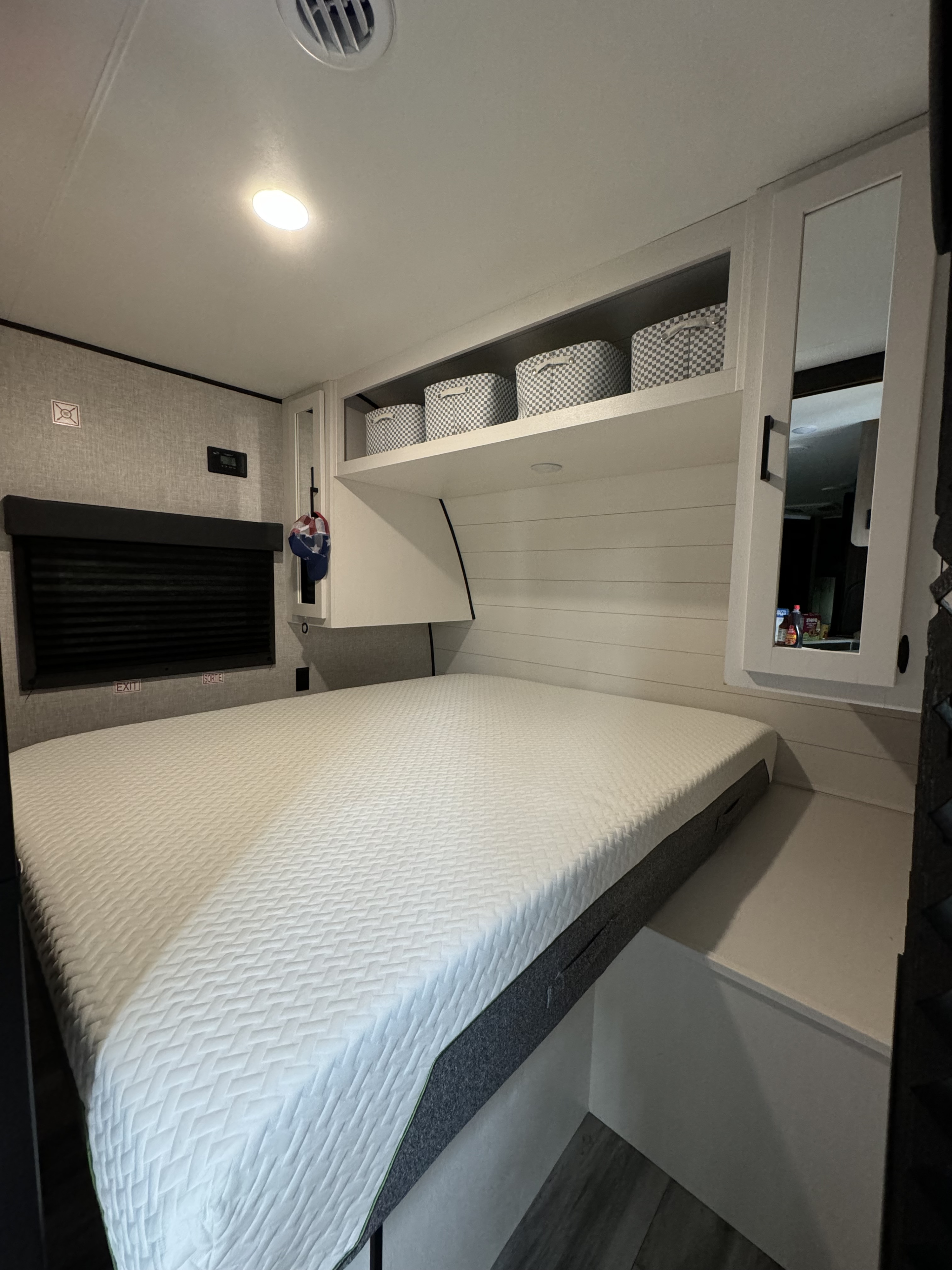 Spacious RV rental bedroom featuring a comfy queen bed, smart storage, and modern interior for relaxing travels.. Starcraft Autumn Ridge 2024