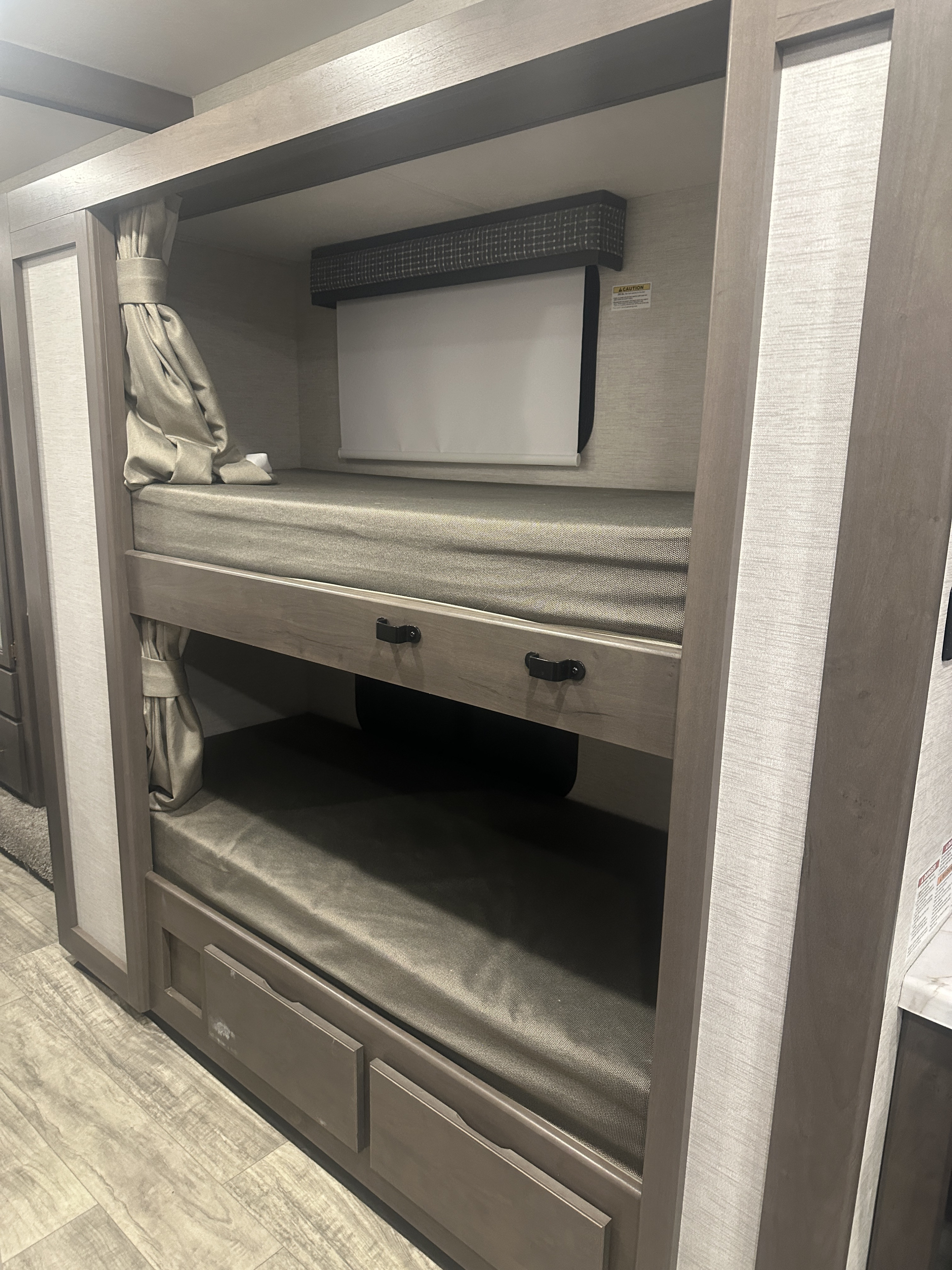 RV rental interior: cozy bunk beds with privacy curtains and storage drawers, perfect for families.. Thor Chateau 2024