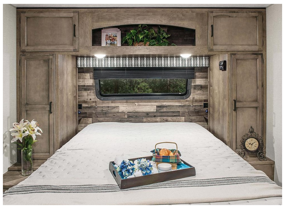 Cozy RV rental bedroom with built-in storage, a comfortable bed, and a window for scenic views, perfect for travel.. Venture Stratus 291VQB 2023