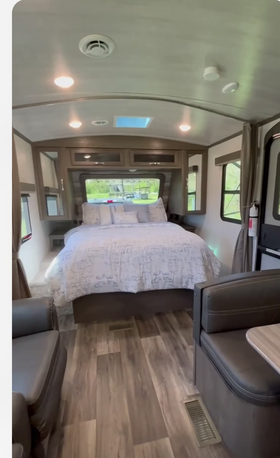 Explore this RV rental's cozy interior, featuring a queen bed, overhead storage, and dinette seating. Your mobile home awaits!. Keystone RV Cougar 2022