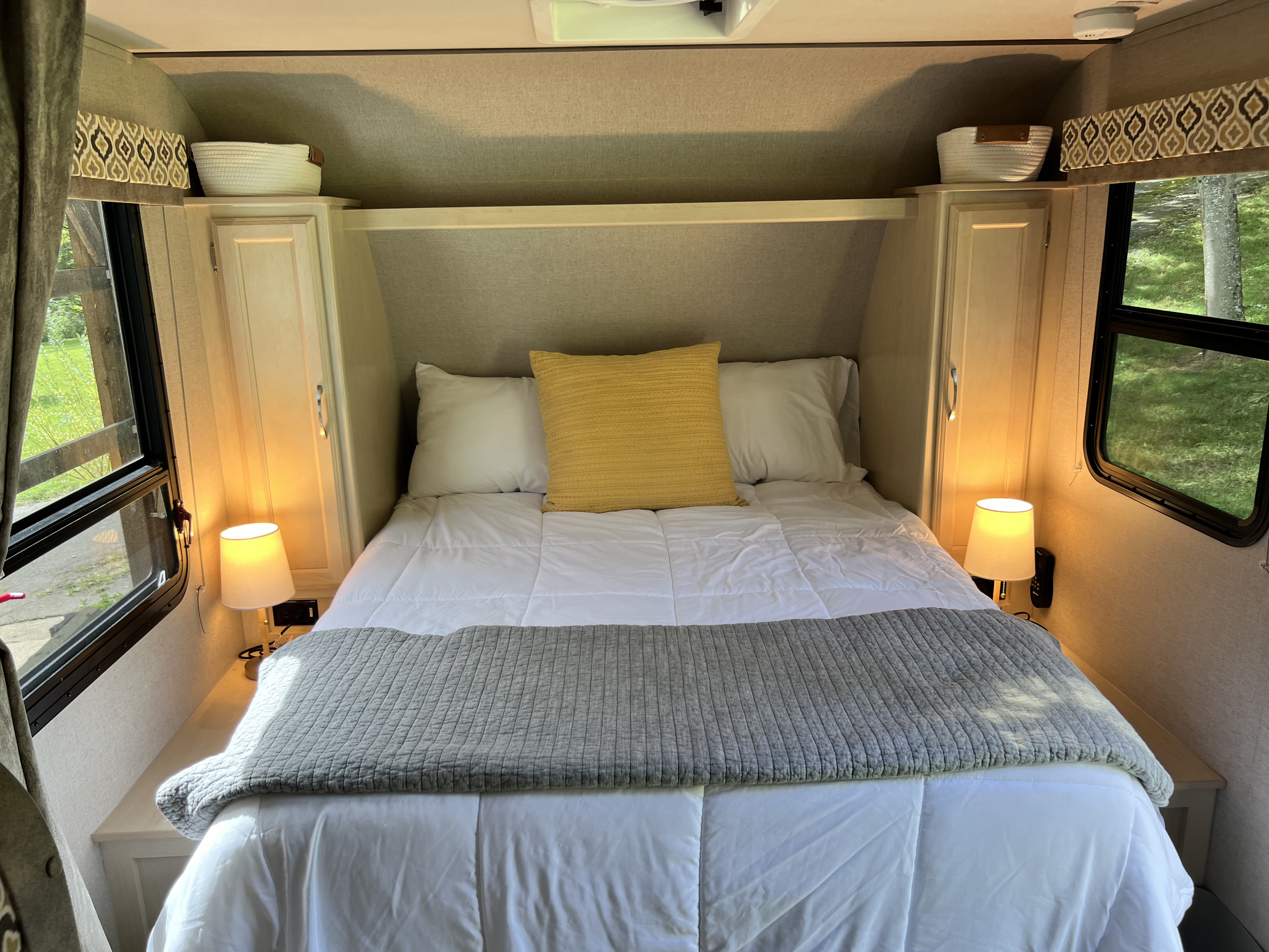 Relax in this comfortable RV rental bedroom featuring a cozy bed, ambient lighting, and storage.. Winnebago Micro Minnie 2306BHS 2019