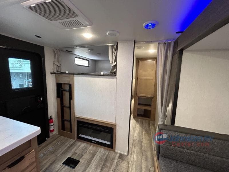 Step inside this modern RV rental! View the inviting bunks, electric fireplace, and ample living space for your adventure.. Forest River Cherokee 294GEBG 2024