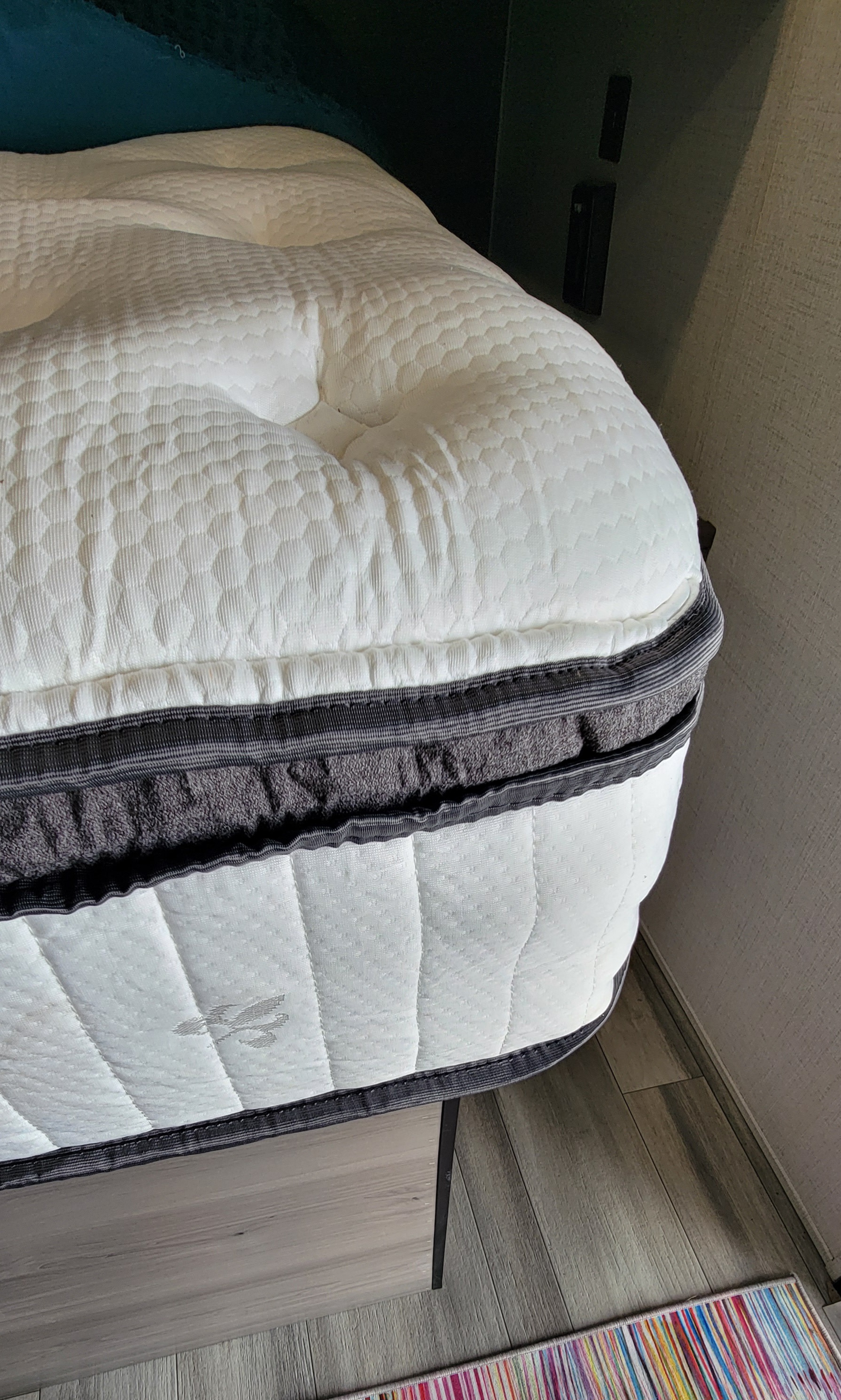Close-up of a premium mattress inside an RV rental, highlighting its quilted top and multi-layered design for comfort.. Keystone RV Hideout LHS Mini 2024