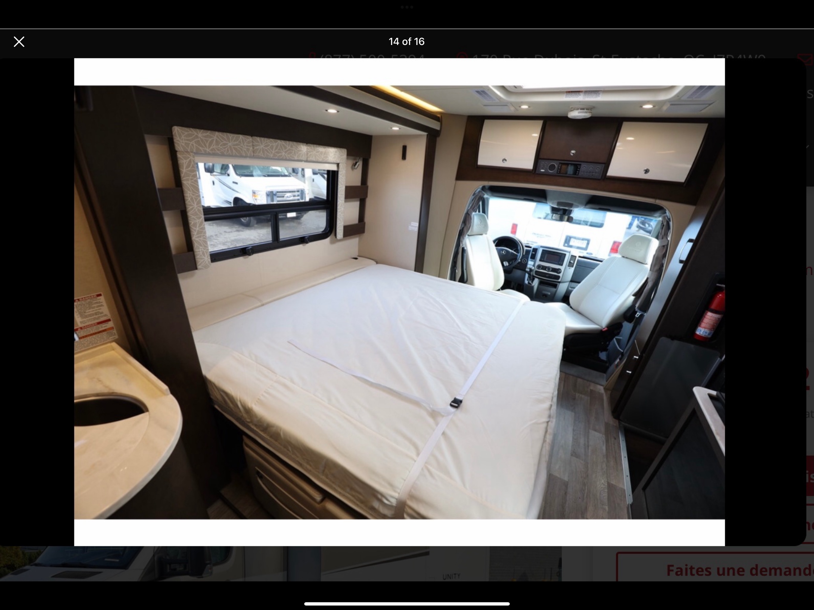 Spacious interior of an RV rental featuring a comfortable bed, cockpit area, and ample storage for your road trip adventures.. Leisure Travel Van Unity MB24 2016