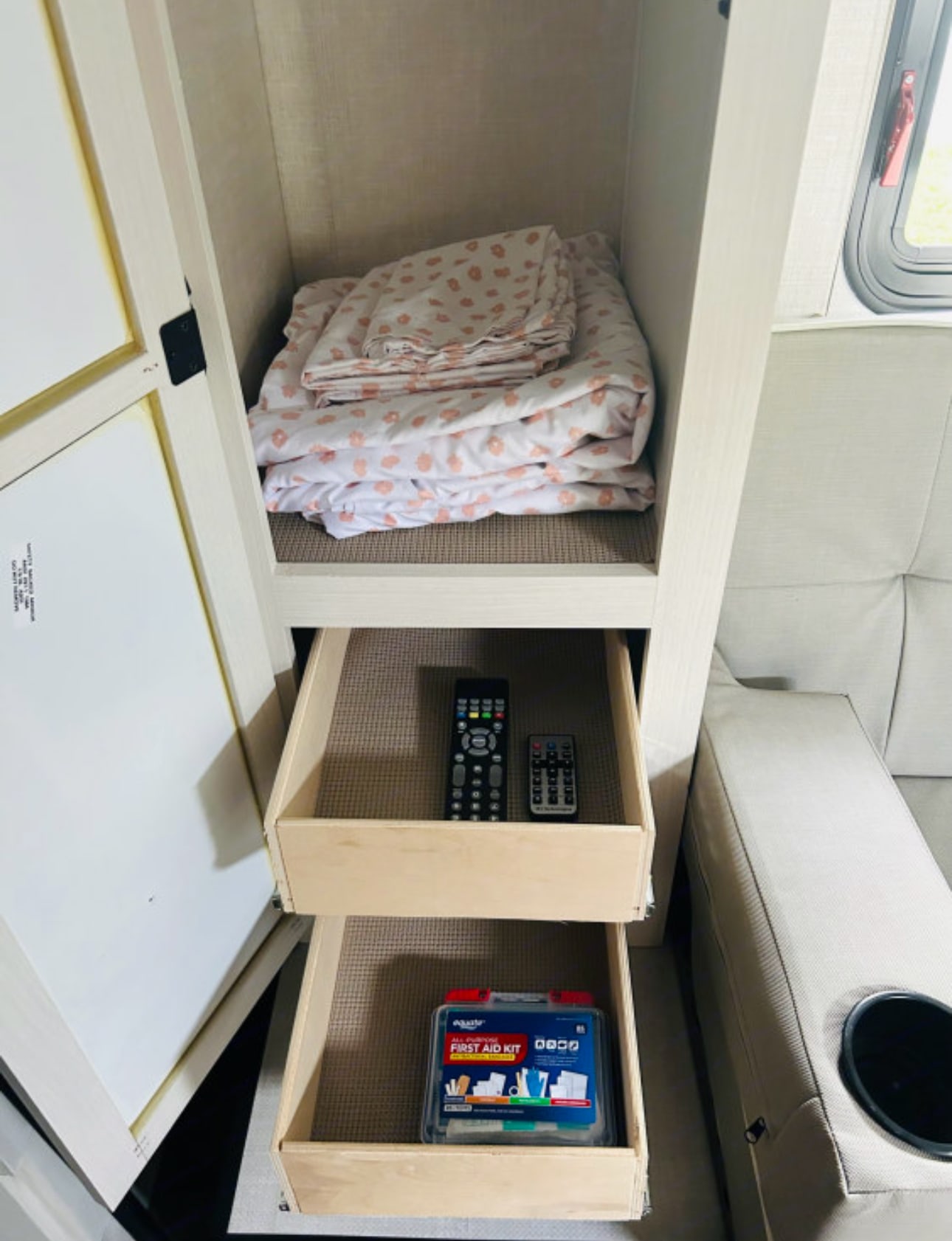 Organized RV rental storage: Bedding, remotes, & first aid kit neatly tucked away in pull-out drawers & shelves.. R-Pod R-Pod Trailer 2022