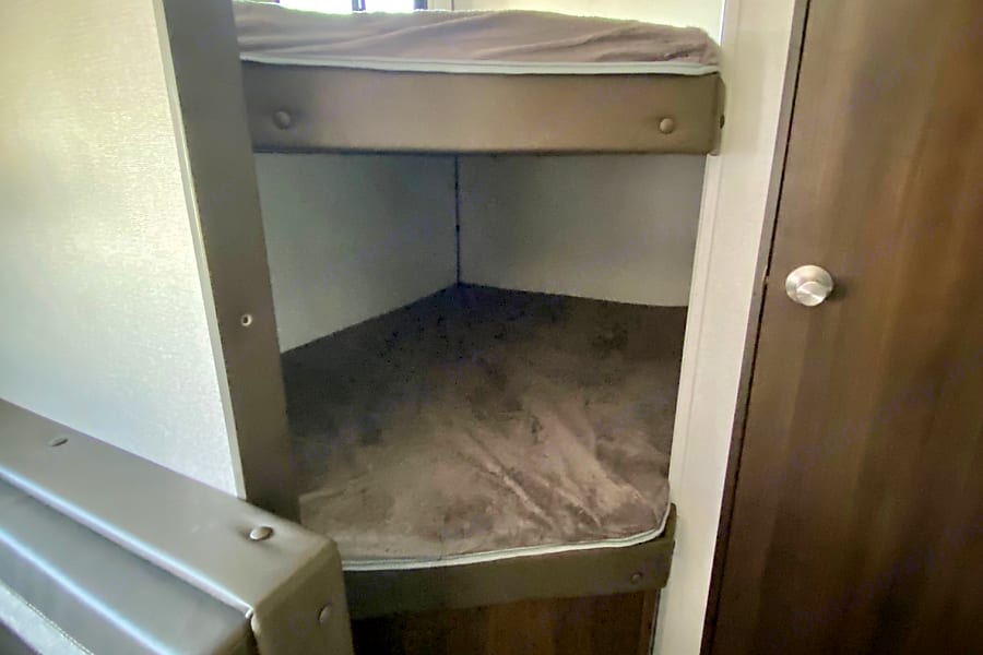 RV rental with built-in bunk beds: an upper and lower mattress in a compact sleeping area.. Keystone Springdale 2021
