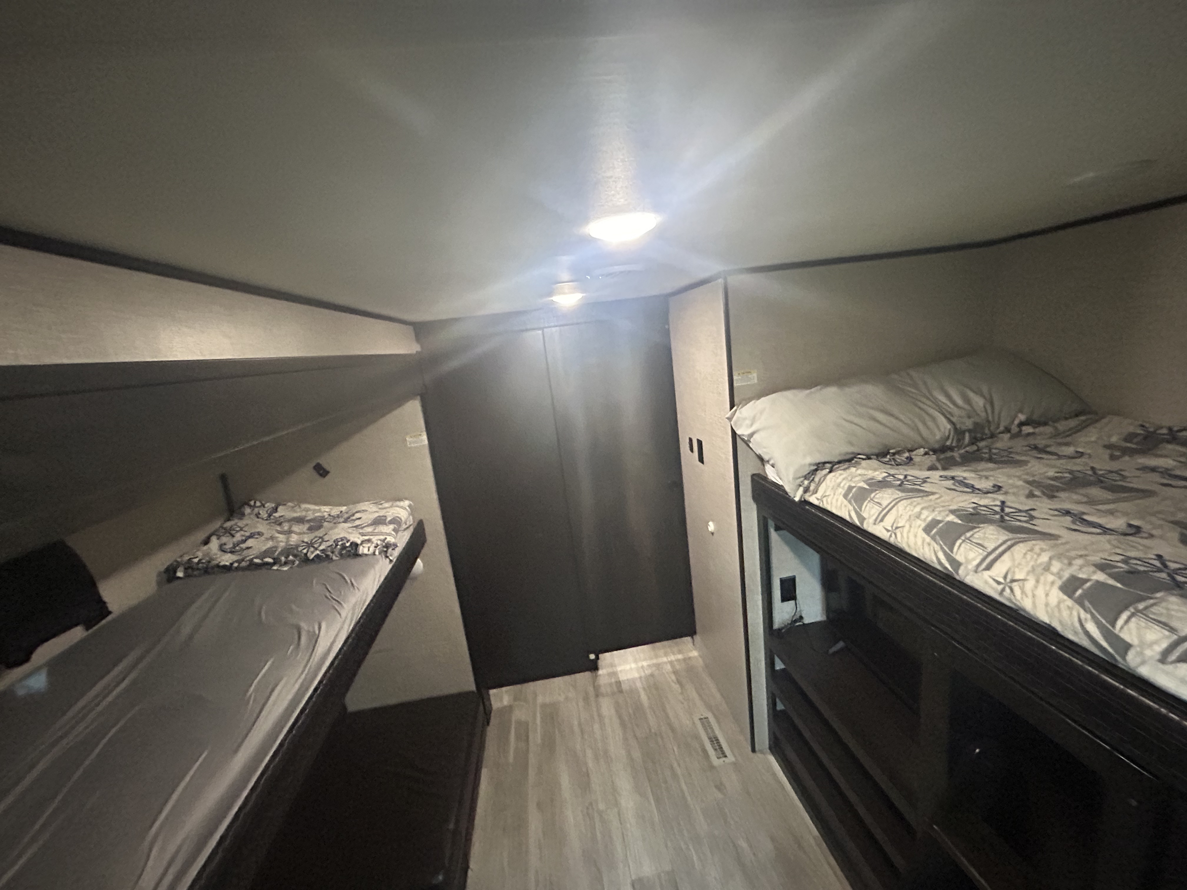 Cozy RV rental bunk beds with bedding, ready for guests. Compact sleeping area perfect for family trips.. Jayco Jay Flight 2022