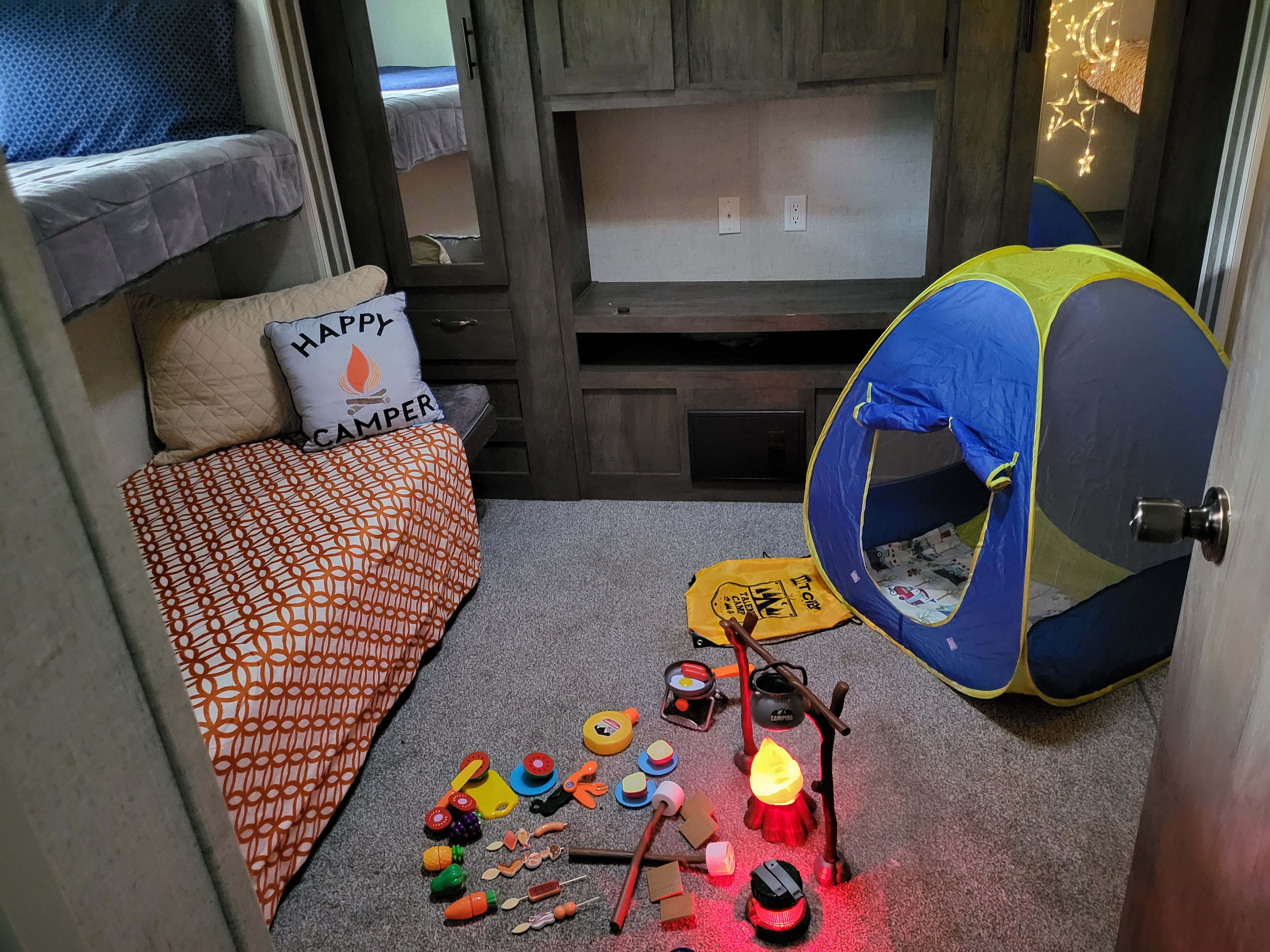 This RV rental bunk room offers cozy beds and a fun camping play area for kids, complete with a tent and campfire toys.. Forest River Salem 2021