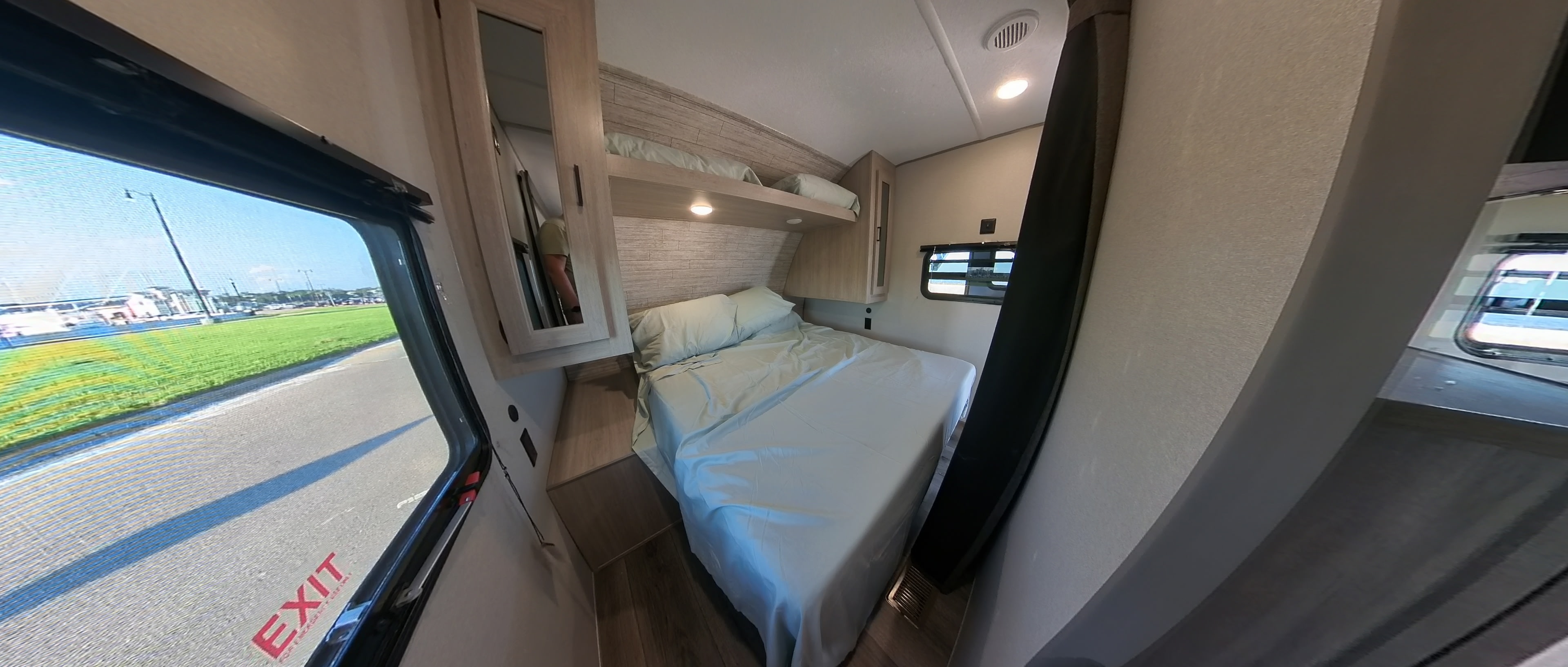 RV rental: Inside a spacious bunkhouse RV, featuring a comfortable bed and overhead bunk for family adventures.. Coachmen Catalina 2024