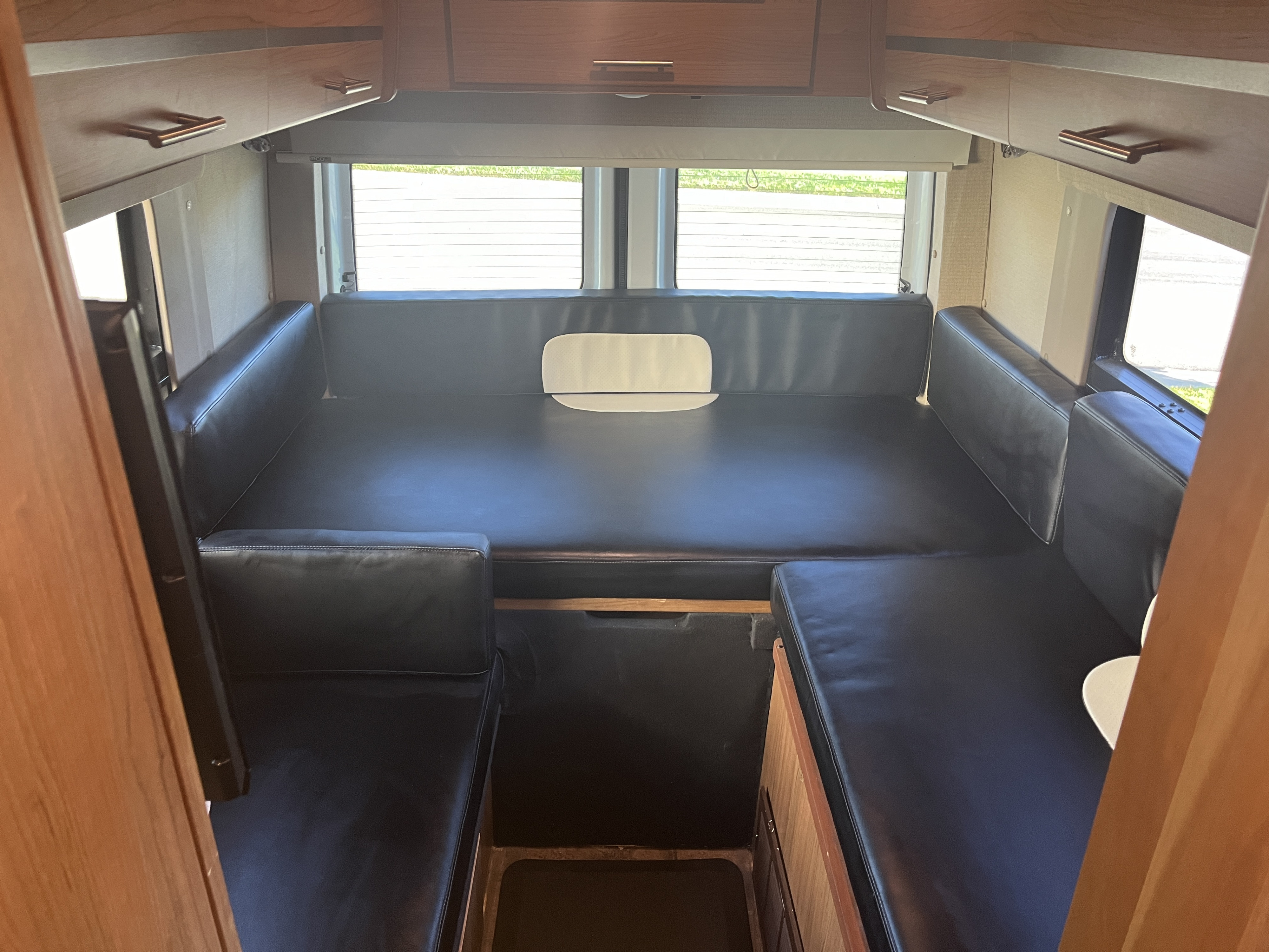 RV rental: Compact interior features convertible black leather seating, overhead cabinets, and rear windows for travel.. ERA ERA Class B 2014