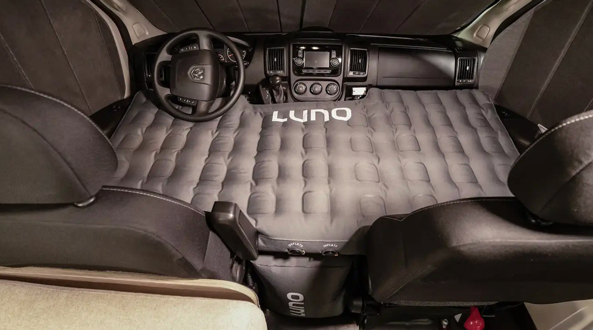 Grey inflatable Luno air mattress converts an RV rental's front cabin into a comfortable bed for vehicle camping.. Winnebago Solis 36A 2023