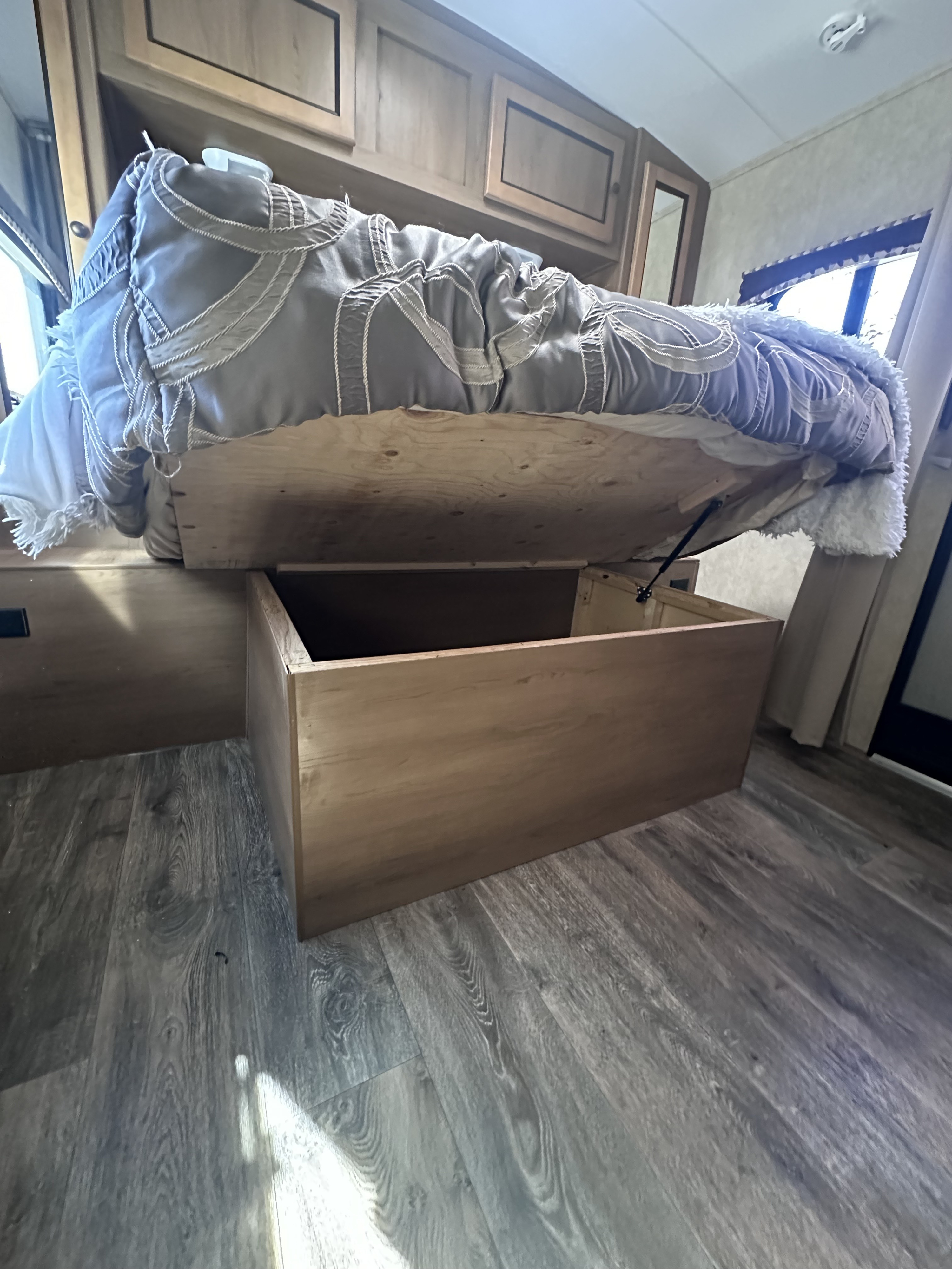 This RV rental offers a bedroom with a lift-up bed, showcasing under-bed storage & overhead cabinets for maximized space.. Cruiser RV Shadow Cruiser 2016