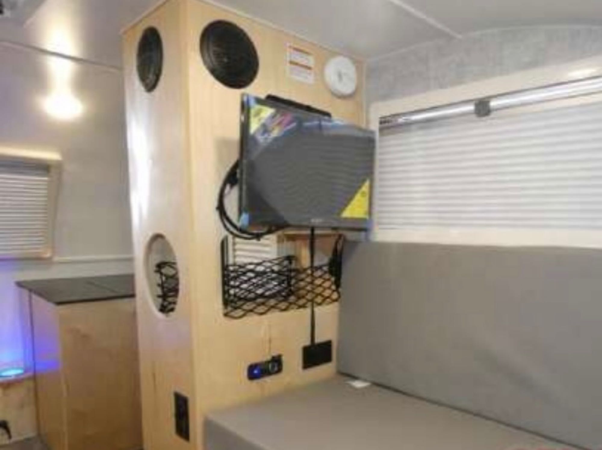 RV rental interior with entertainment: TV, speakers, built-in storage, and comfortable bench seating.. Xtreme Outdoors Little Guy Micro Max CT 2024