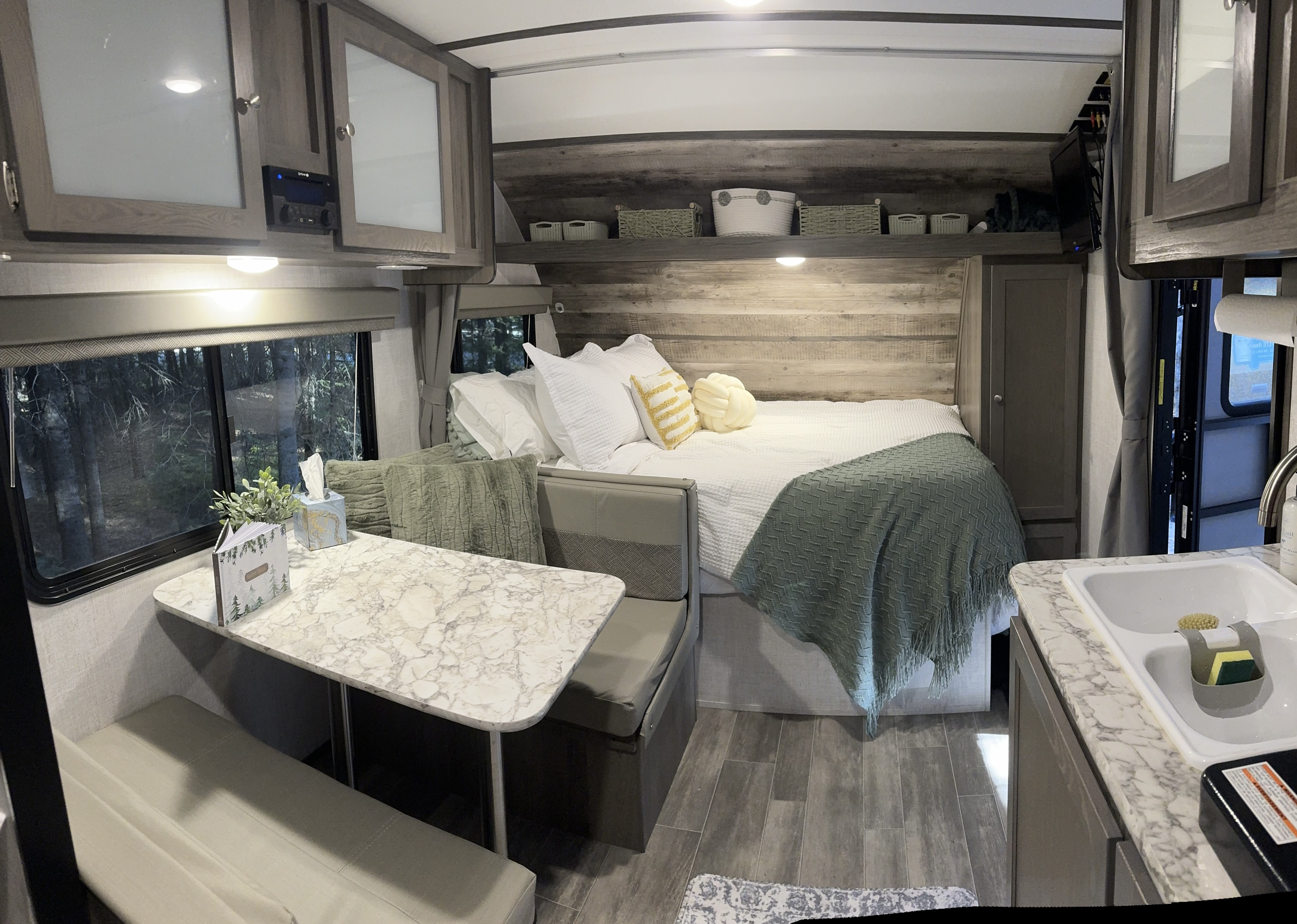 Cozy RV rental interior: bedroom, dinette, and kitchen sink, designed for comfortable travel.. Gulf Stream Northern Express 2021