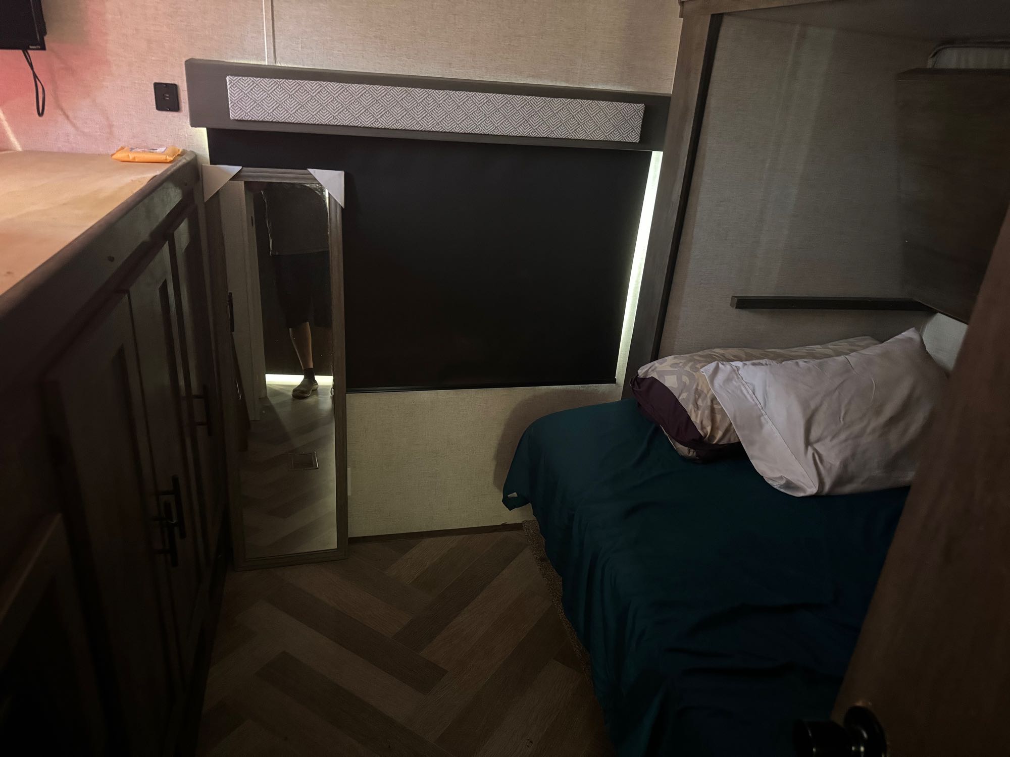 Inside this RV rental: compact bedroom featuring a cozy lower bed, bunk area, mirror, and built-in storage.. Forest River Other 2021