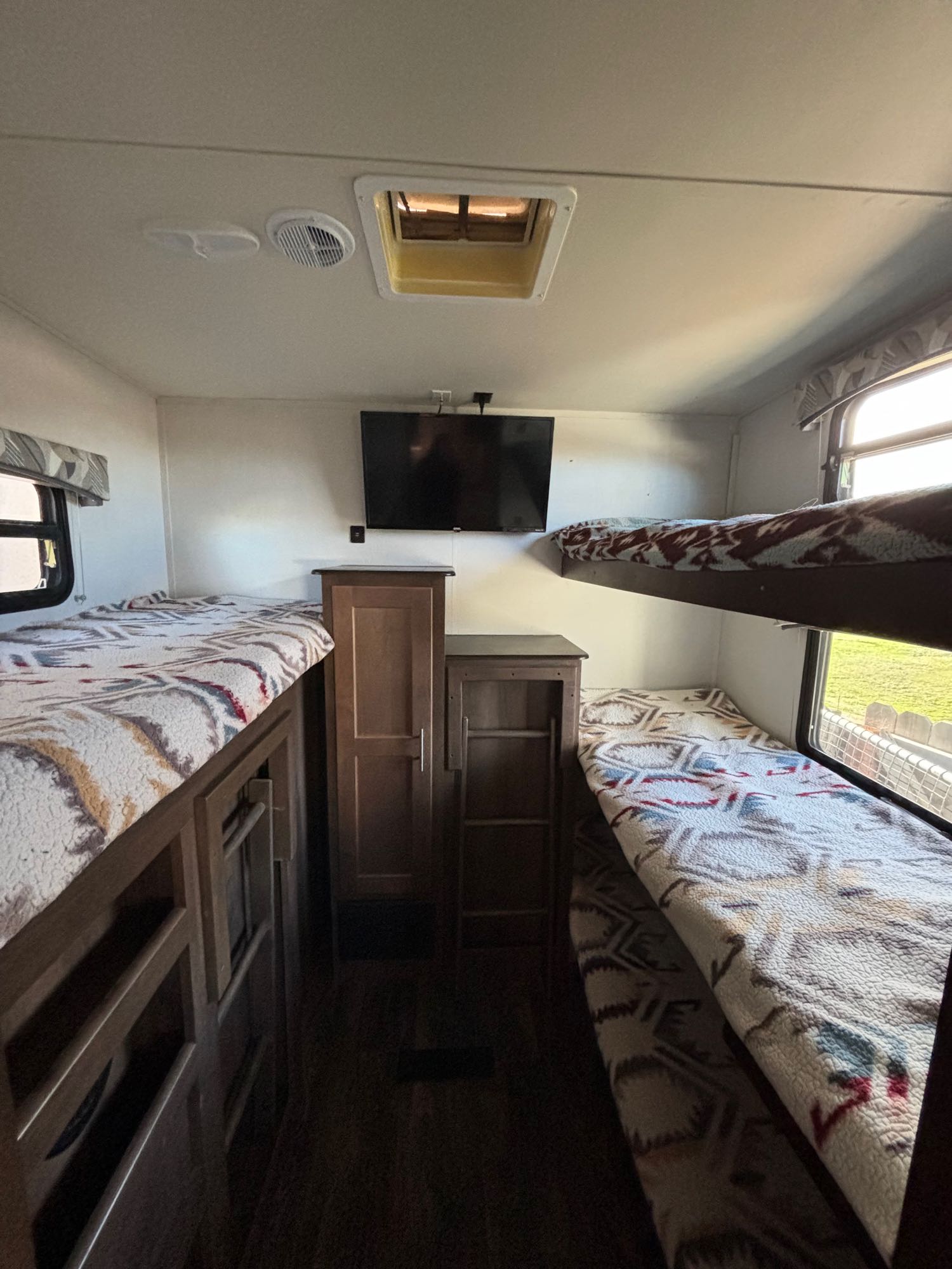 RV rental bunk room: two sets of cozy bunk beds, central storage, and TV. Ideal sleeping area for your next road trip adventure.. Forest River Wildcat Maxx 2017