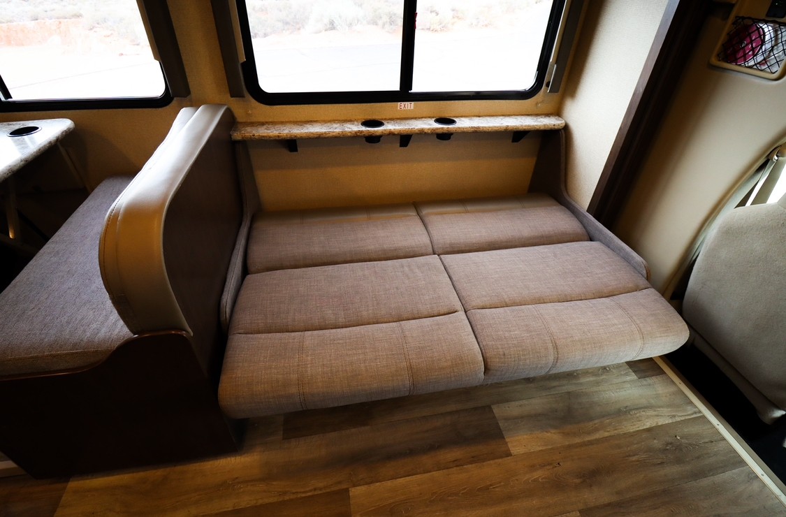 Functional RV rental interior: Dinette seating converts to a bed, maximizing space. Features large windows and durable flooring.. Thor Freedom Elite 2019