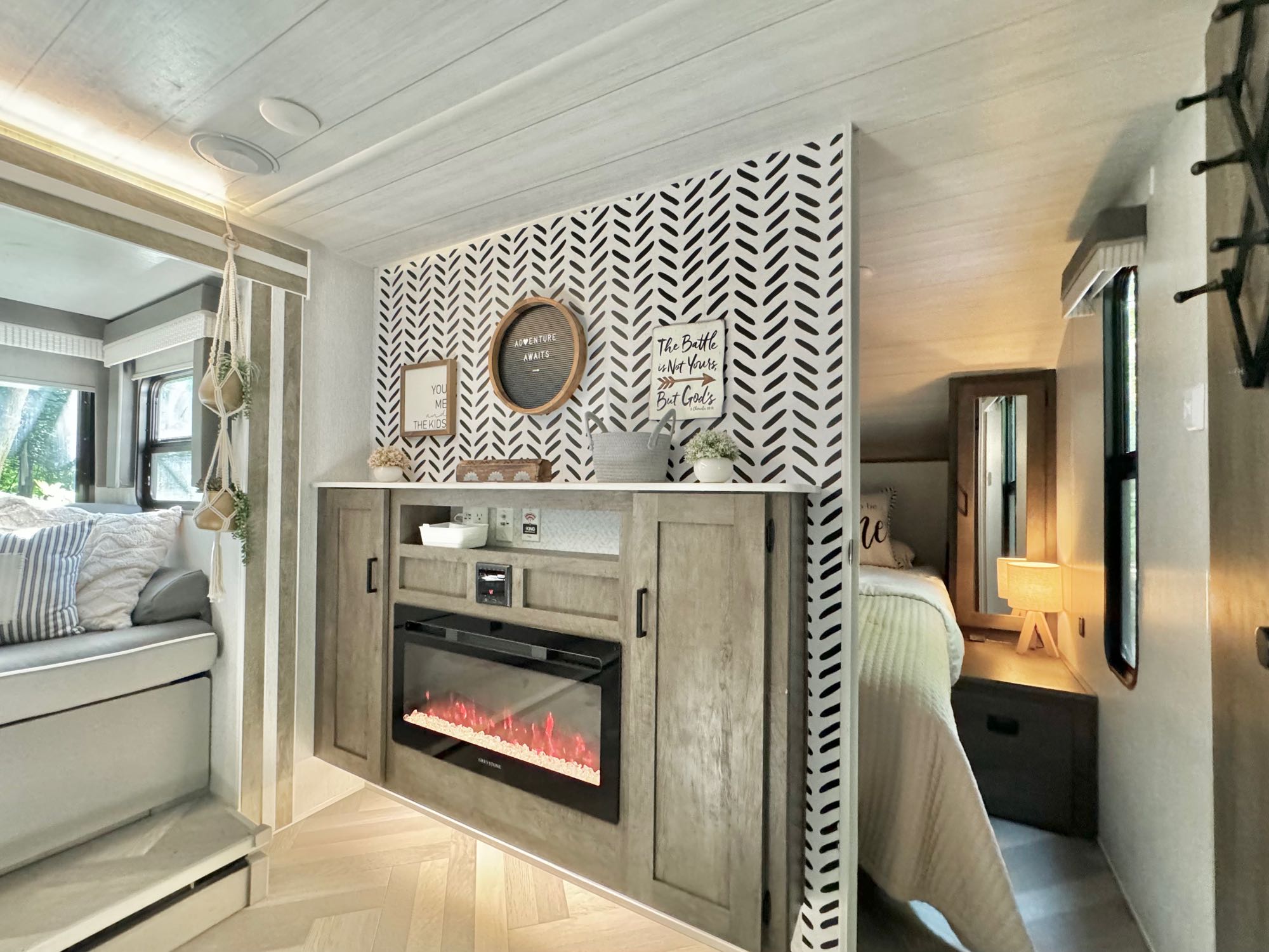 Cozy RV rental interior with a built-in electric fireplace, stylish decor, and clever use of space. Perfect for families.. Forest River Wildwood X-Lite 2023