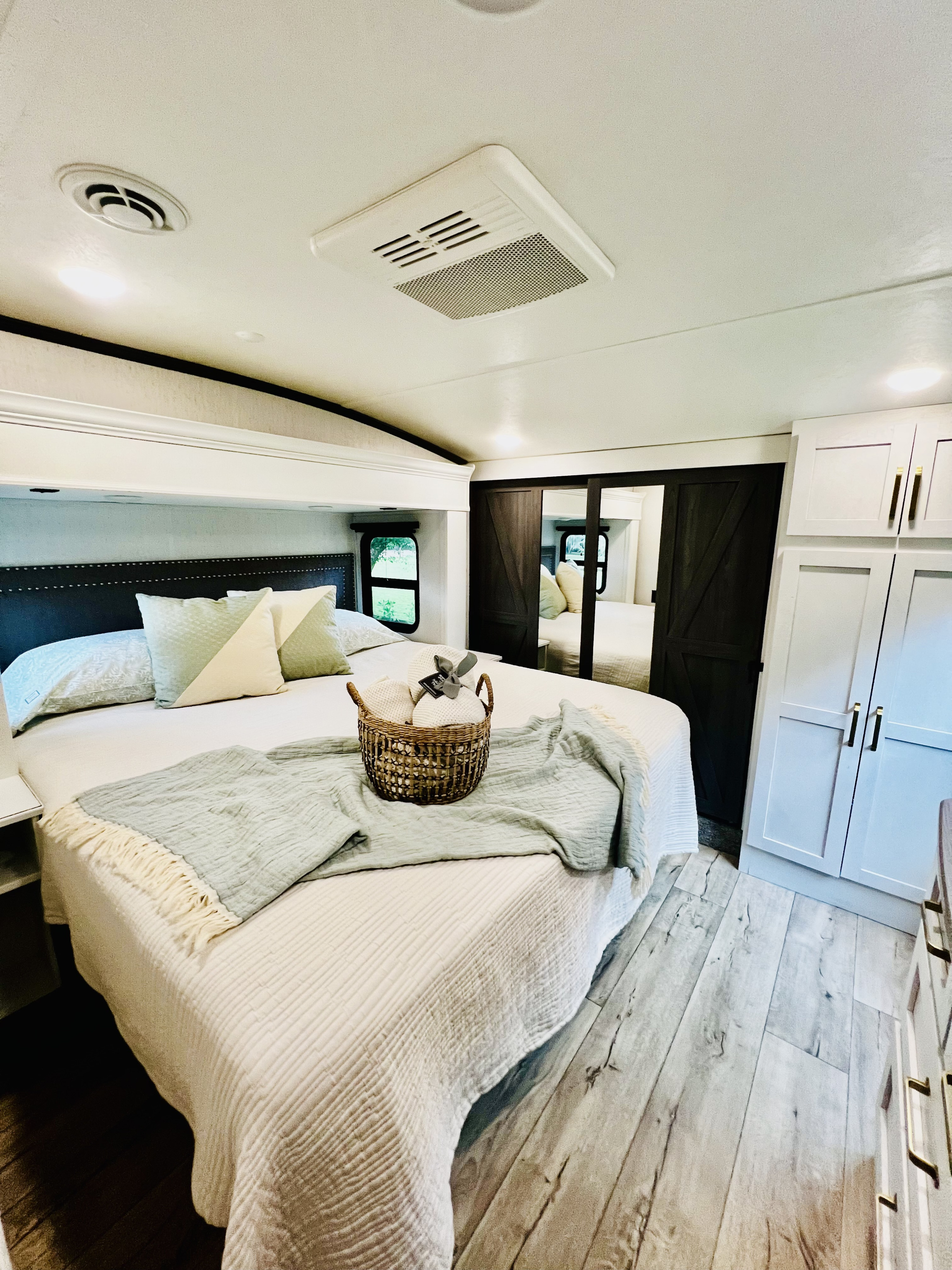 Master bedroom w/ Kind bed, storage, iron/ironing board, washer & dryer combo in closet w/ detergent & dryer sheets included.. Dutchmen 3603LFP 2022